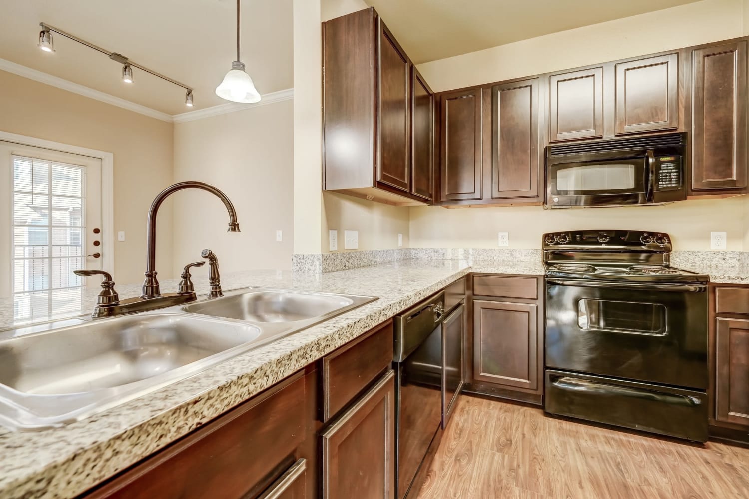 Modern Kitchen with granite counter tops at Chateau Mirage Apartment Homes in Lafayette, Louisiana