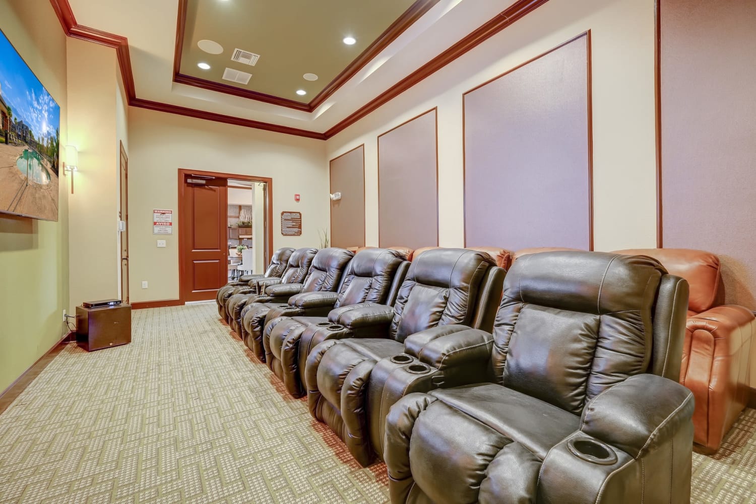 Theatre room with leather recliners and big screen tv at Chateau Mirage Apartment Homes in Lafayette, Louisiana