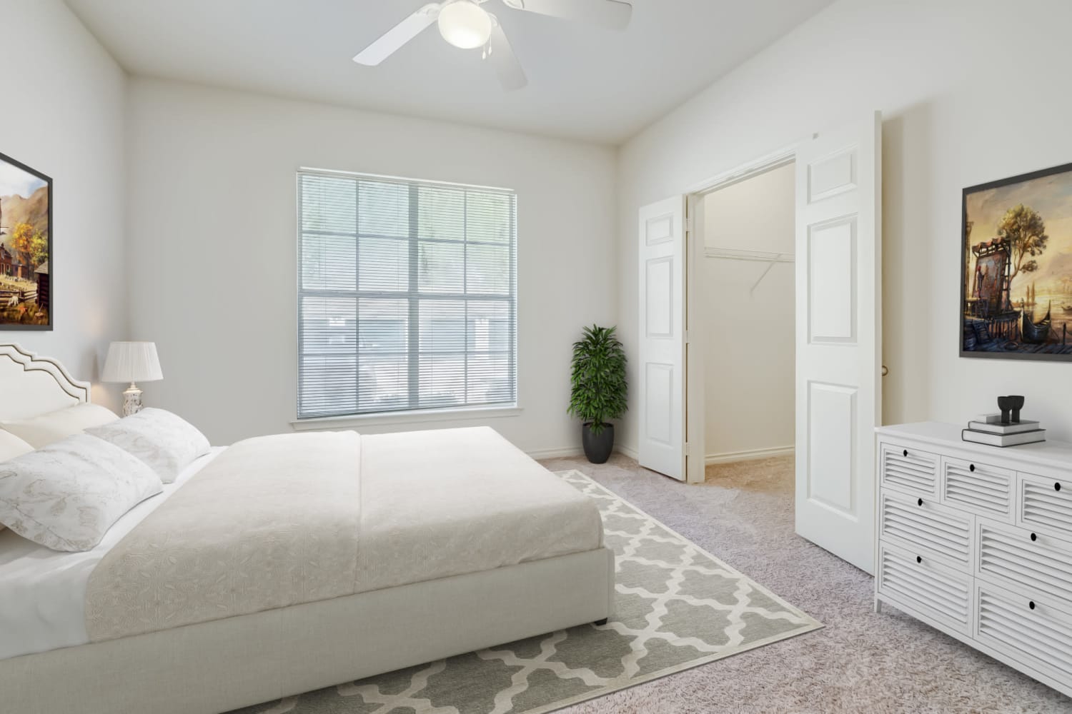 Bedroom with large window at Audubon Lake Apartments