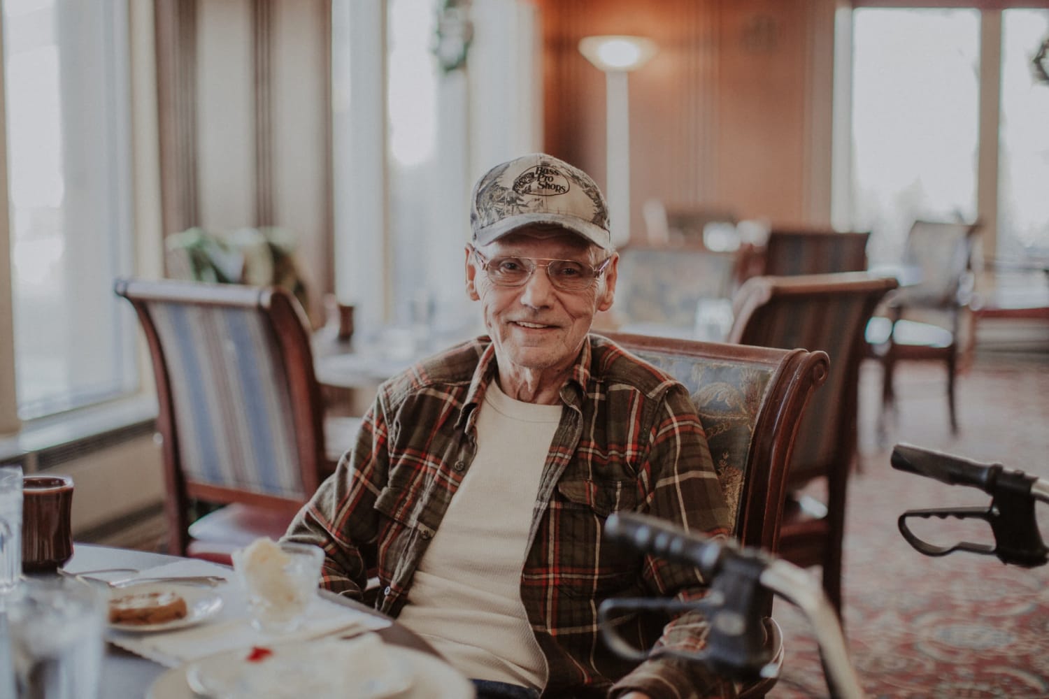 Resident smiling in the dining hall at The Whitcomb Senior Living Tower in St. Joseph, Michigan