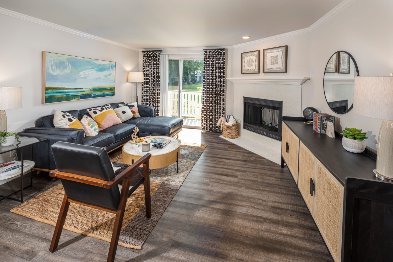 Spacious living room with sliding glass door to outside patio at The Preserve at Forbes Creek in Kirkland, Washington