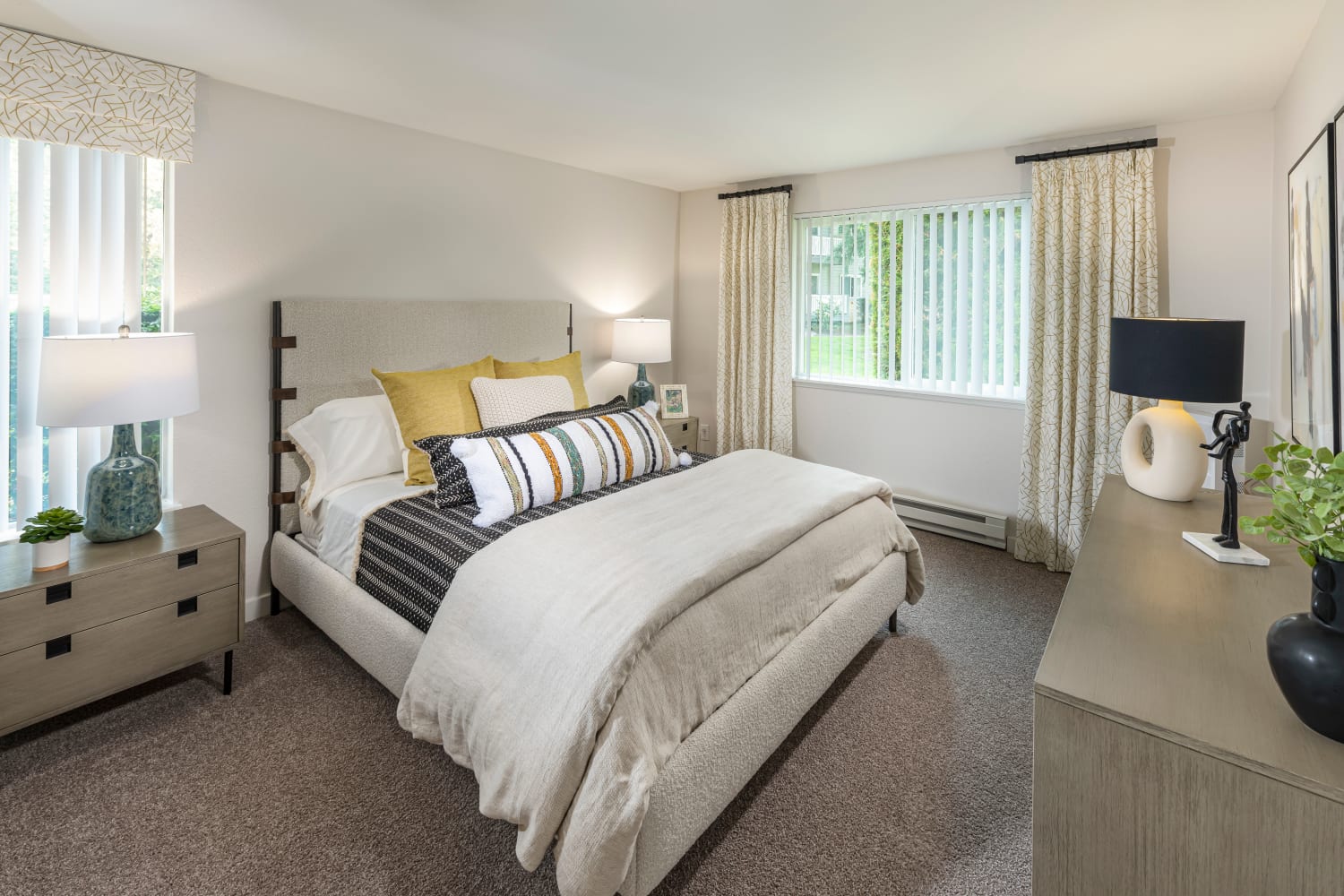 Spacious bedroom with ample natural light from large windows at The Preserve at Forbes Creek in Kirkland, Washington