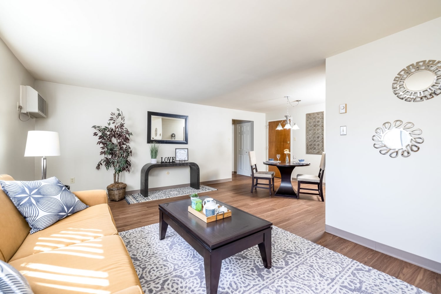 Spacious living room fully furnished with kitchen access Maiden Bridge & Canongate Apartments in Pittsburgh, Pennsylvania