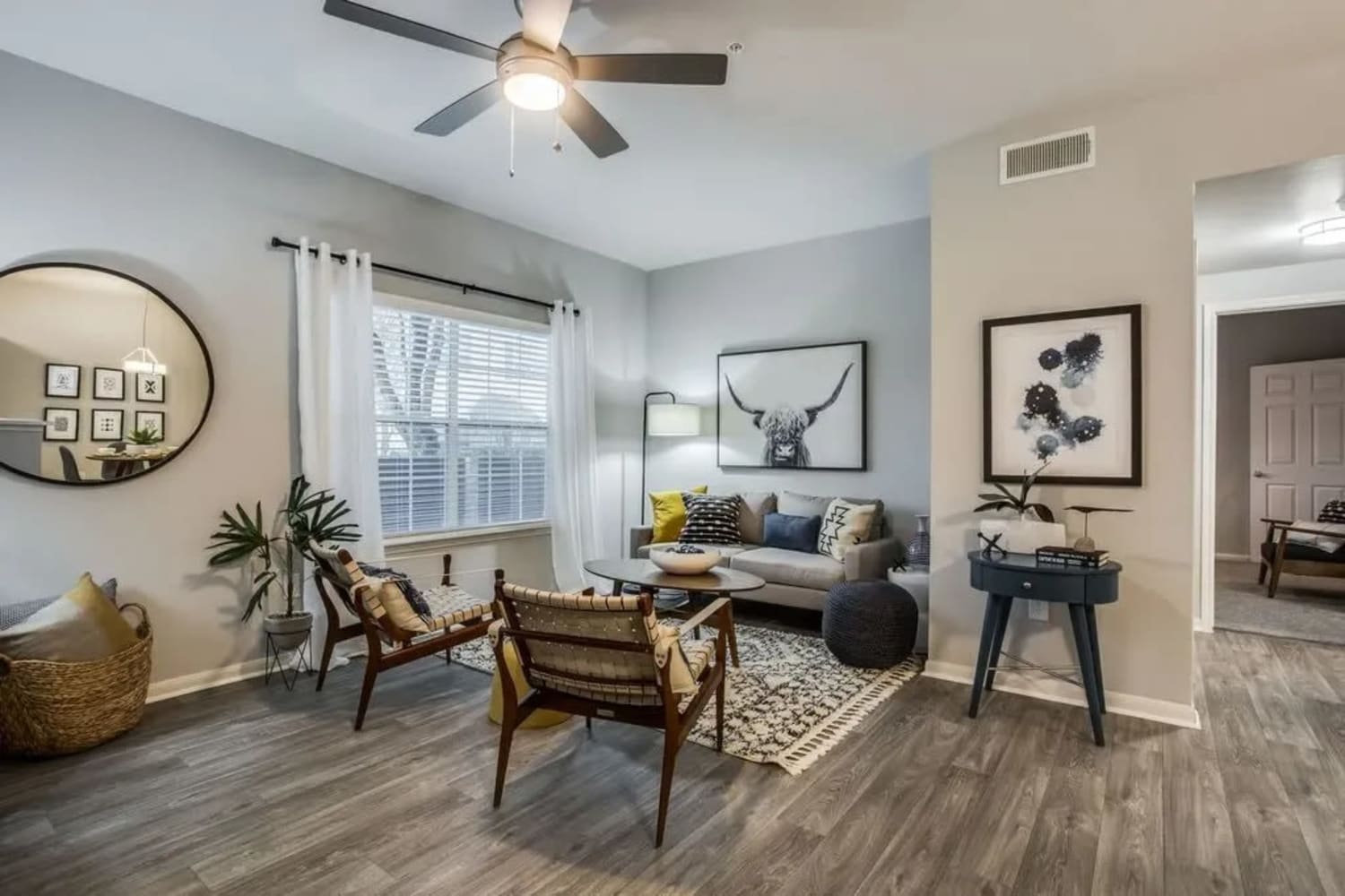 Model living room with window at Oak Grove Apartments in Houston, Texas