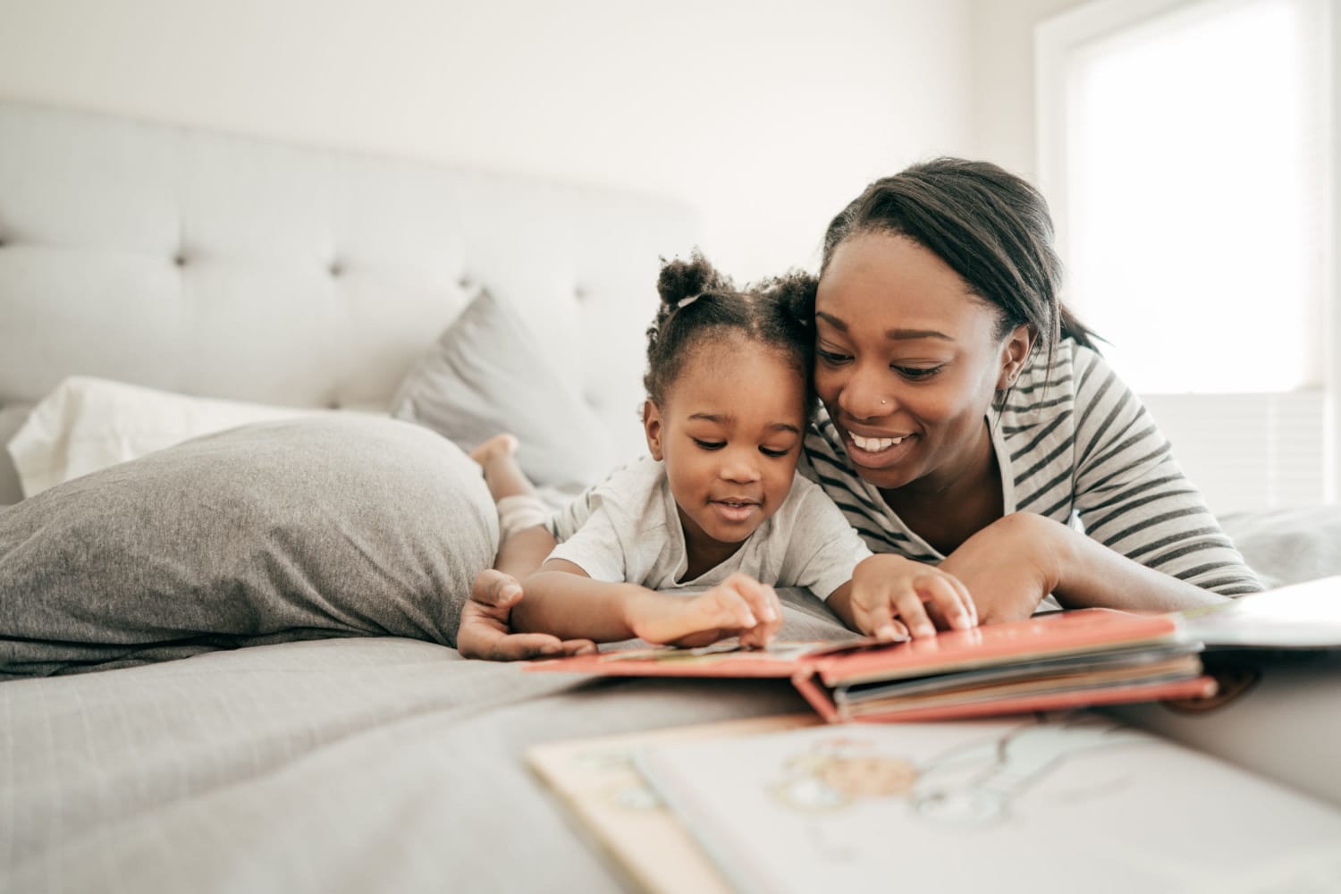 Mother reading story for her daughter at Wadsworth Park Apartments in Los Angeles, California