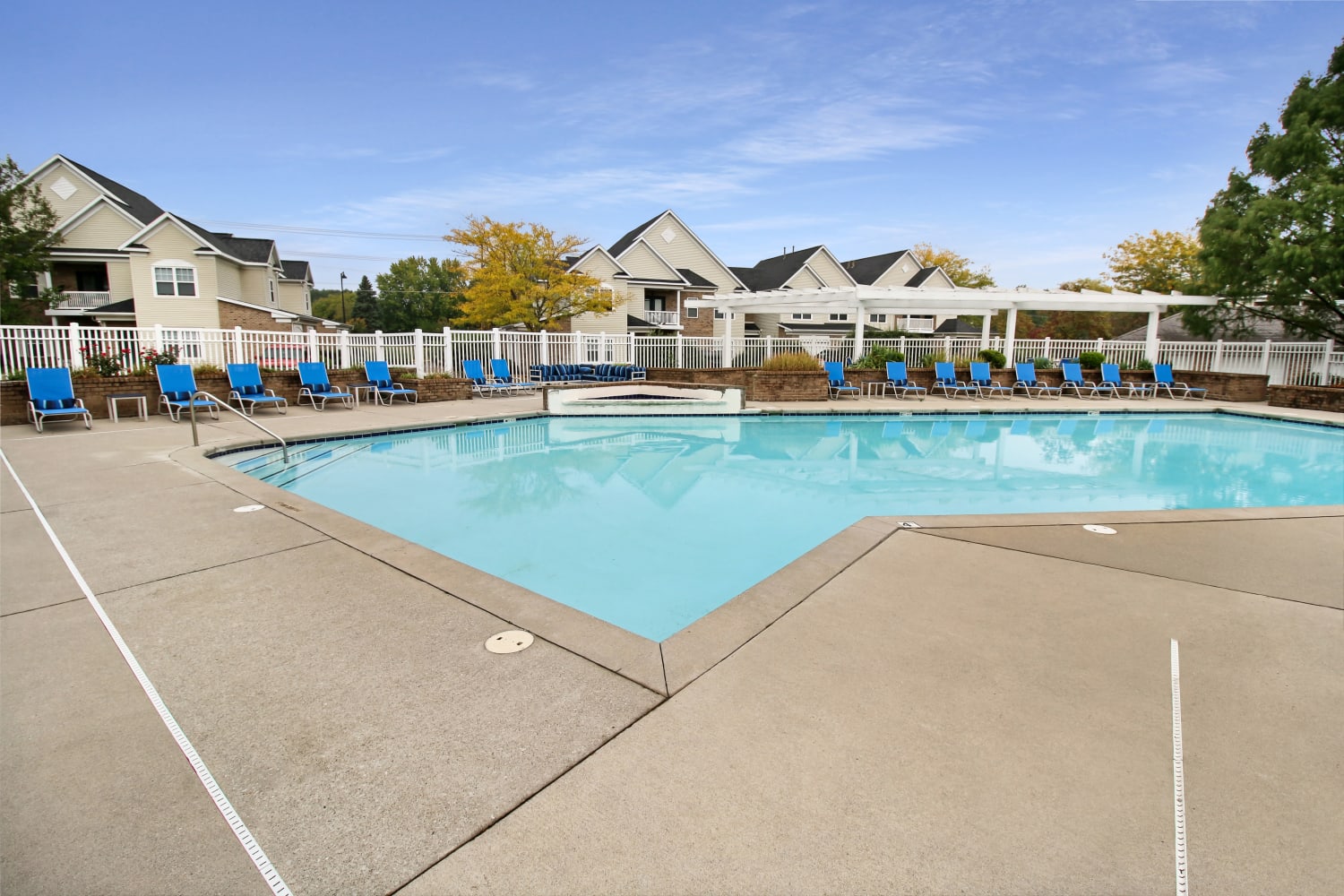 Swimming pool and lounge chairs at Avalon at Northbrook Apartments & Townhomes in Fort Wayne, Indiana