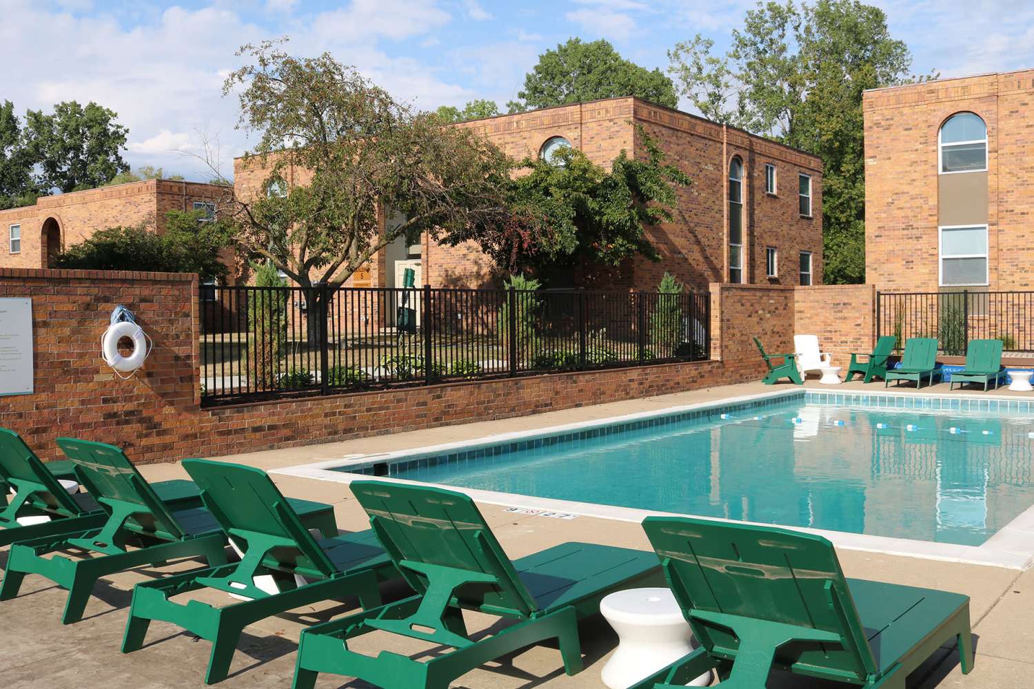 Community pool with lounge seating at The Quarters at East Lansing in East Lansing, Michigan