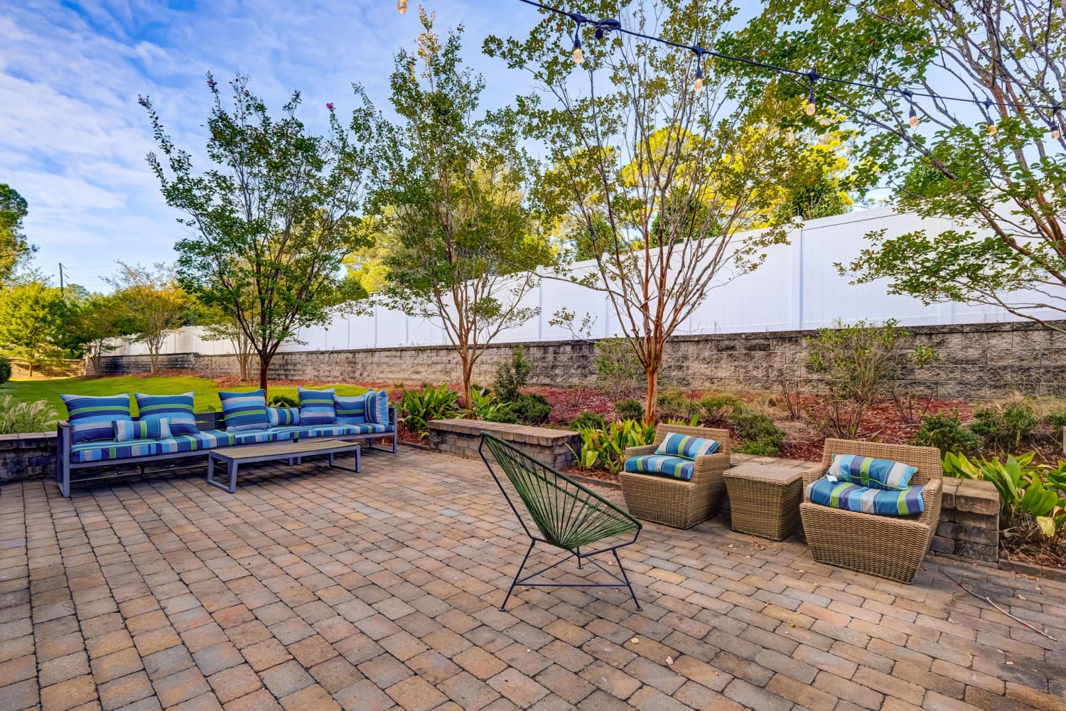 Patio with comfortable furniture and grills at Creekside at Greenlawn Apartment Homes in Columbia, South Carolina