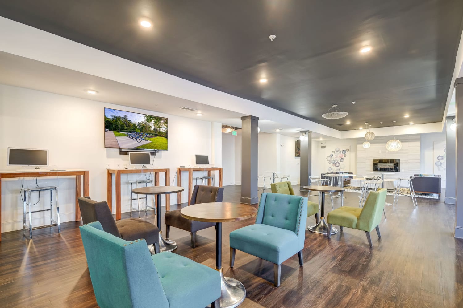 Resident clubhouse with tables and seating at Creekside at Greenlawn Apartment Homes in Columbia, South Carolina