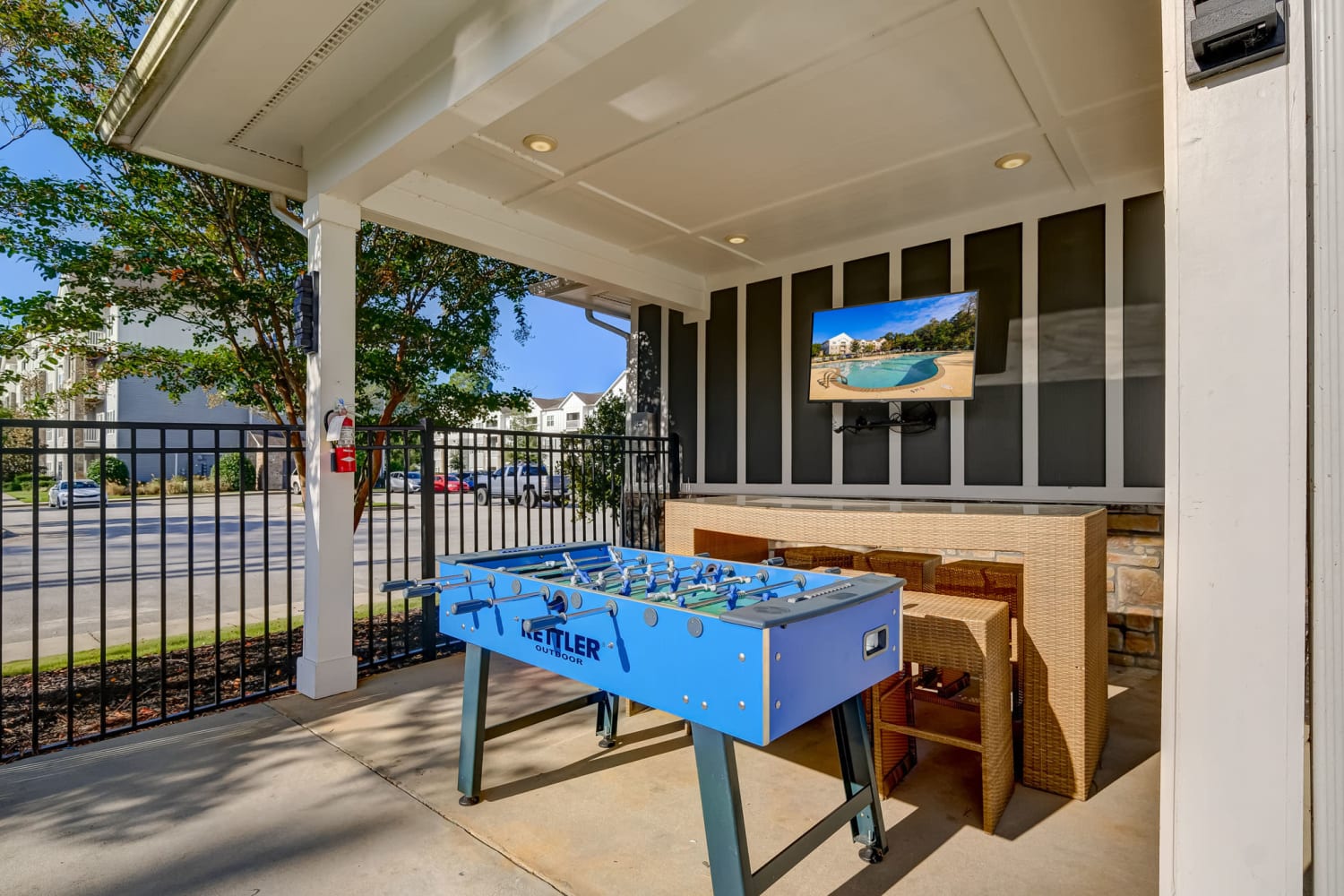 Outdoor bar, tv and foosball table at Creekside at Greenlawn Apartment Homes in Columbia, South Carolina