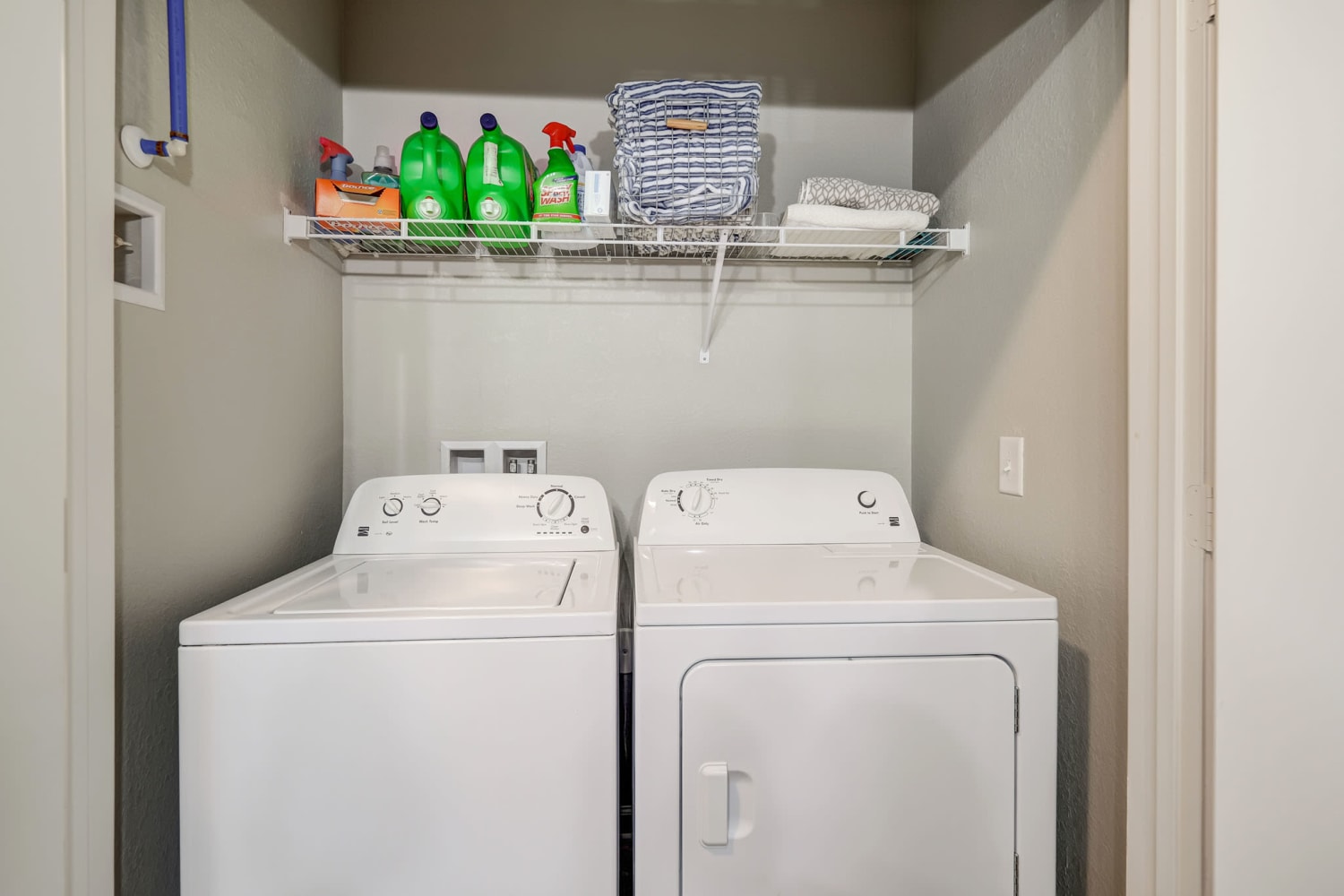 Unit Washer and Dryer with storage above at Creekside at Greenlawn Apartment Homes in Columbia, South Carolina