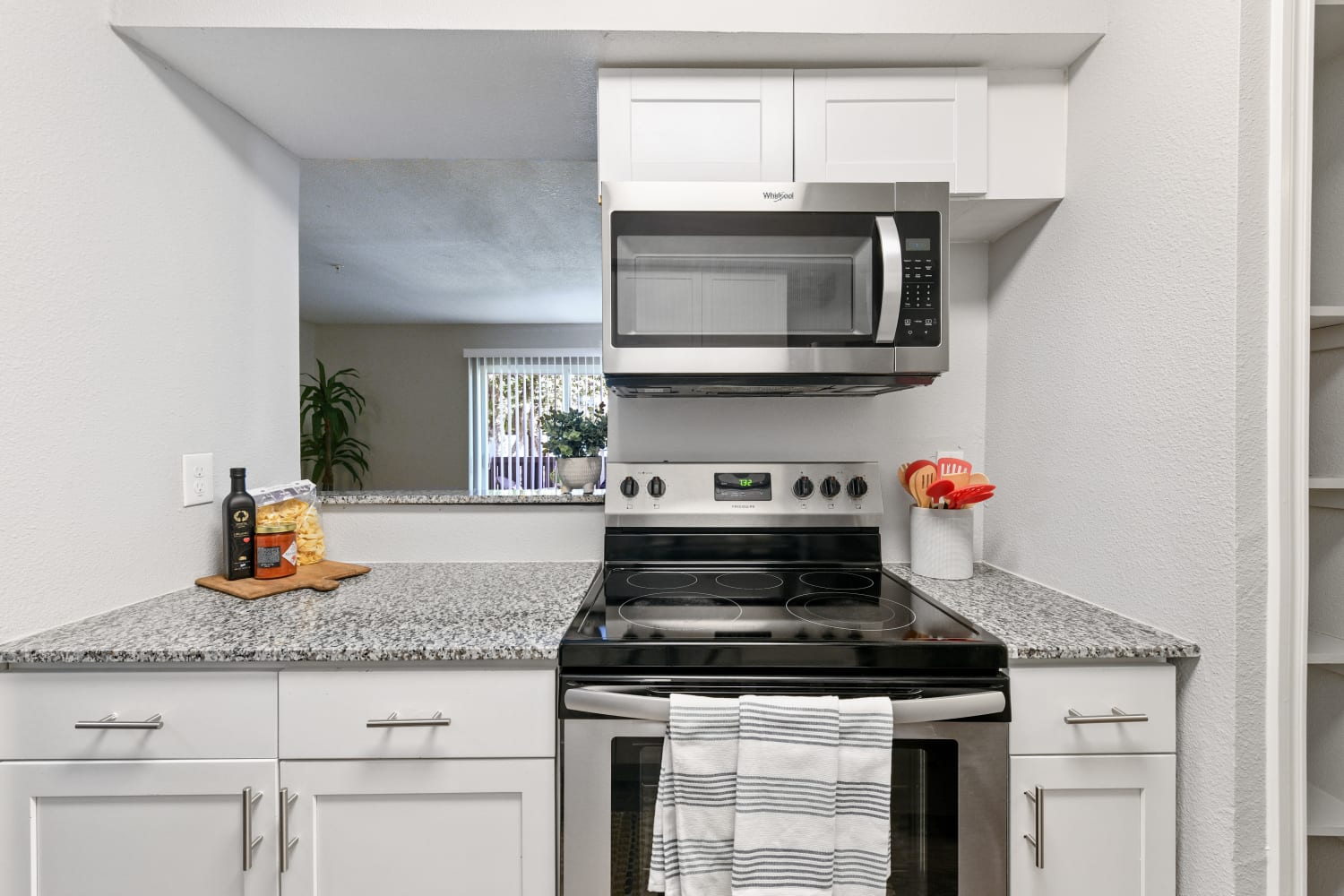 A bright kitchen with appliances at The Broadway in Garland, Texas