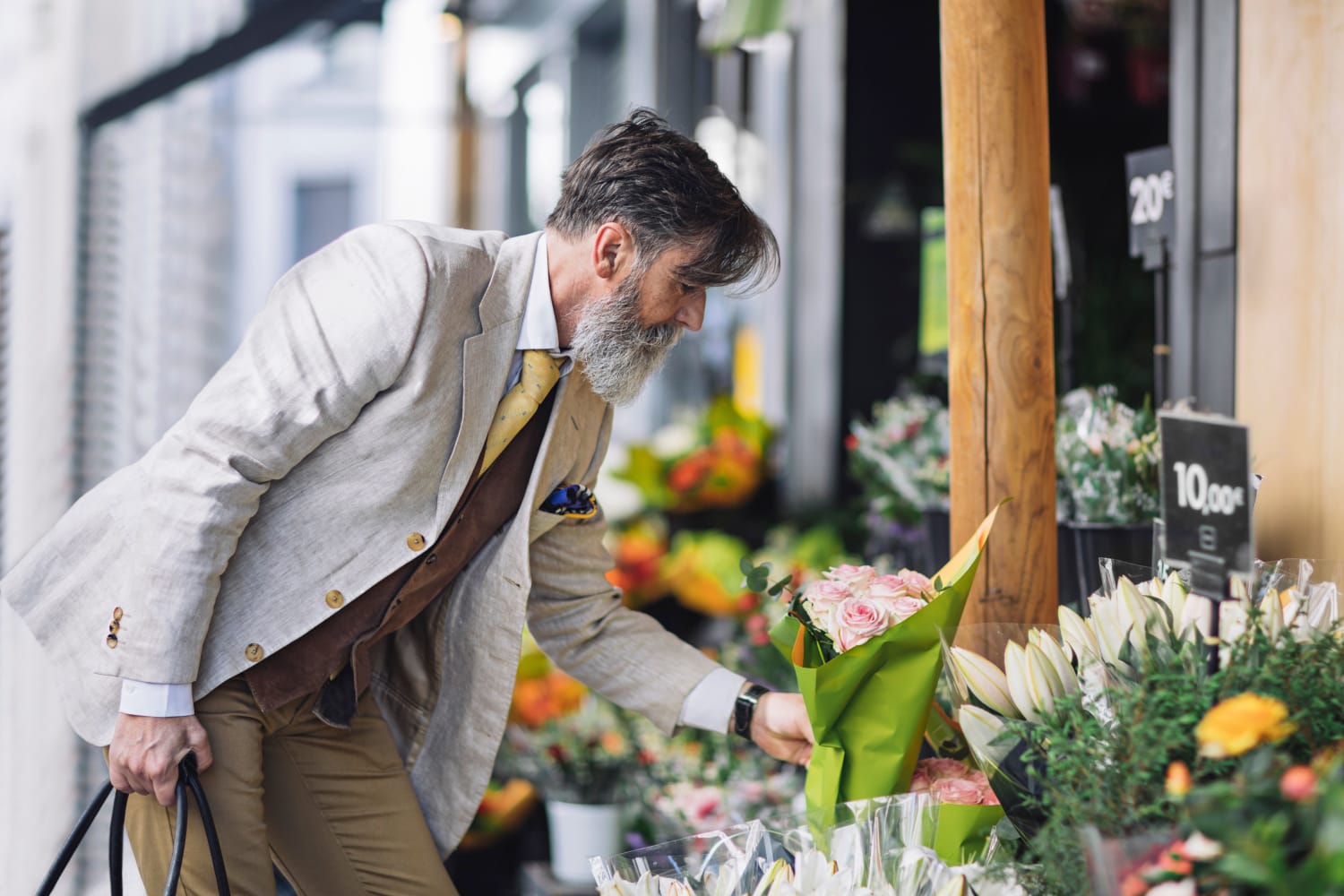 Man in a suit shopping for flowers near Elevation Townhomes in Phoenix, Arizona