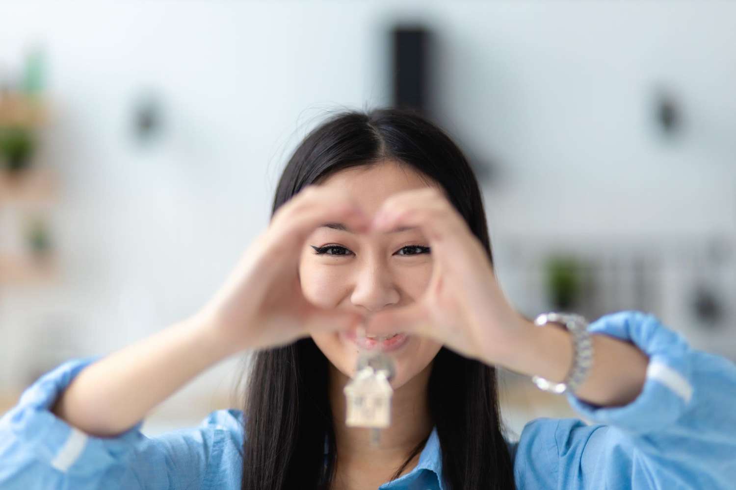 Woman making a heart out of her hands over her face in Sacramento, CA