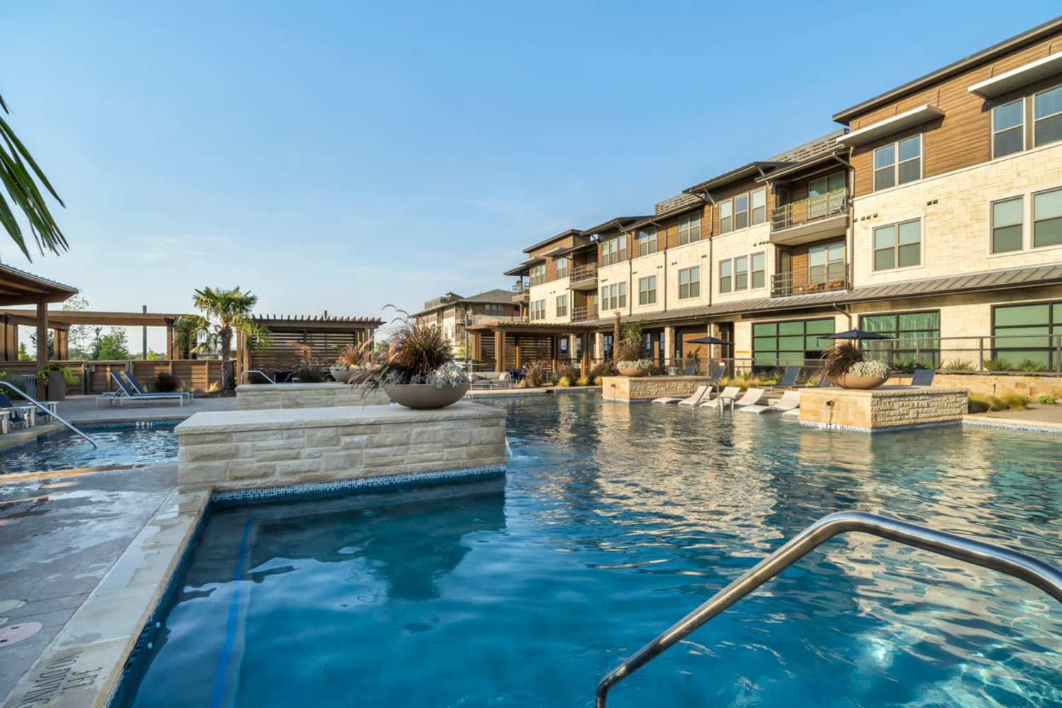 Resort-style pool with poolside seating at Chisholm at Tavolo Park in Fort Worth, Texas