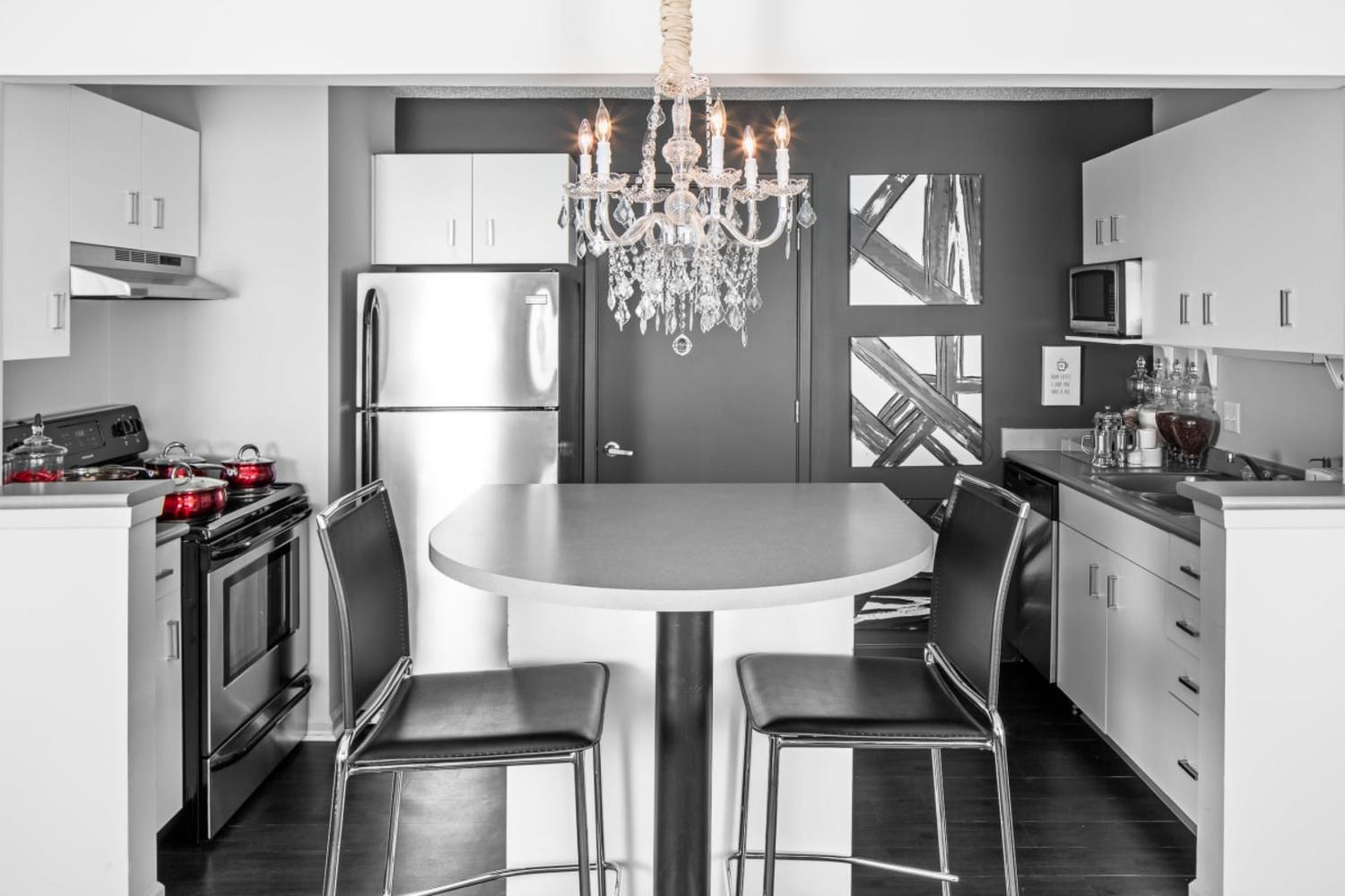 Luxury community kitchen with chandelier at The Gramercy in Manhattan, Kansas