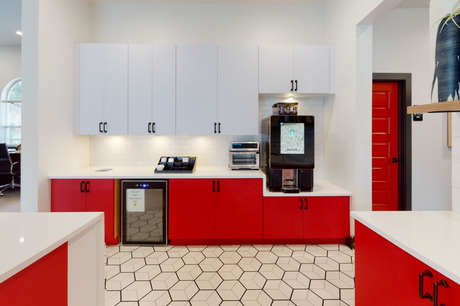 Community kitchen with red and white cabinets at The Quarters at Oxford in Oxford, Mississippi