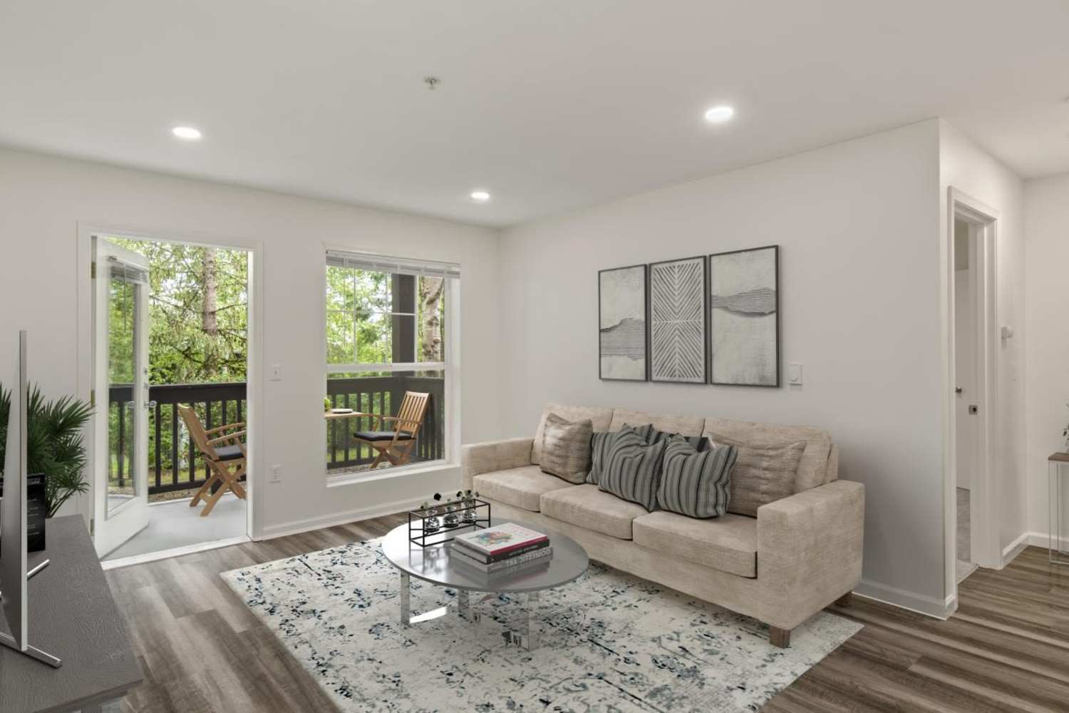 Modern living room with wood-plank flooring at Stonemeadow Farms in Bothell, Washington