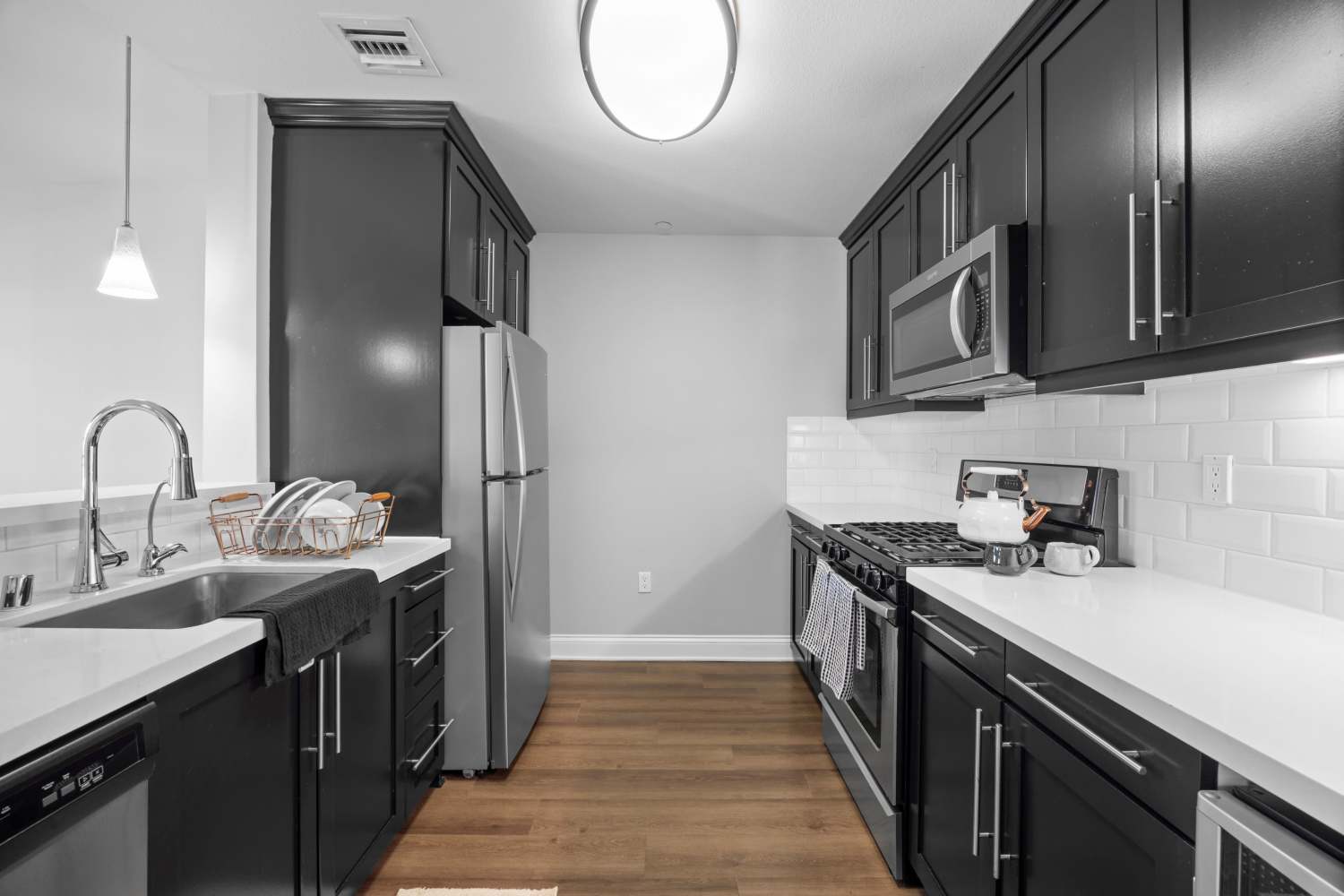 Luxurious kitchen with stainless-steel appliances and quartz slab counters in a model home at La Belle at Hollywood Tower in Los Angeles, California