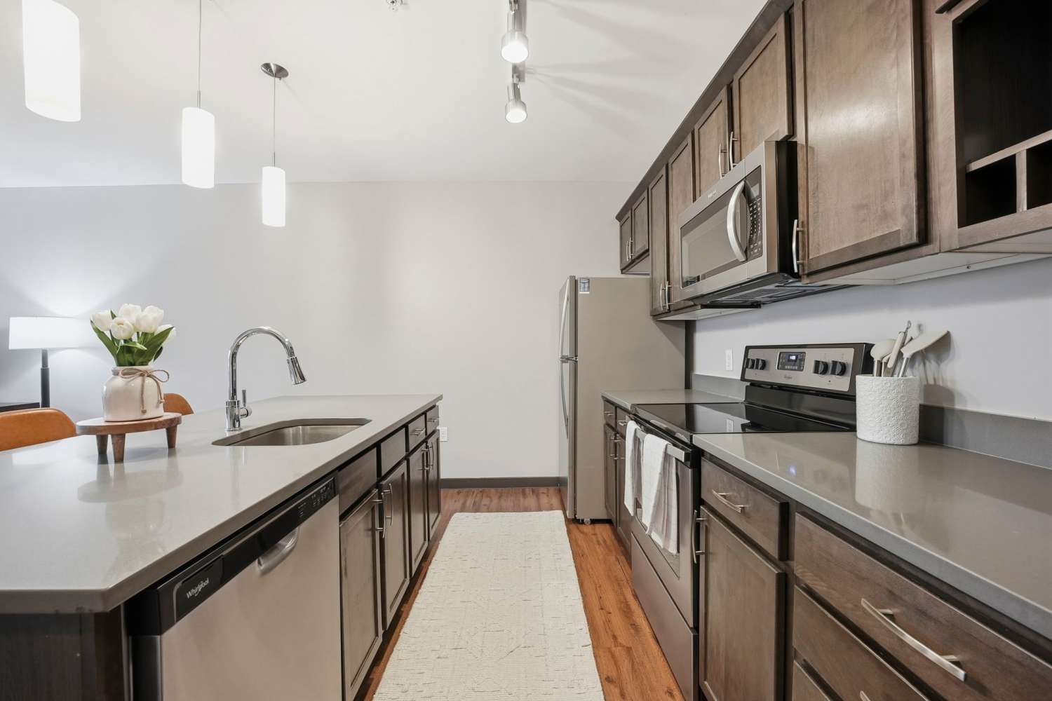 Kitchen in a home with wood-style flooring at Bridge Park in Dublin, Ohio