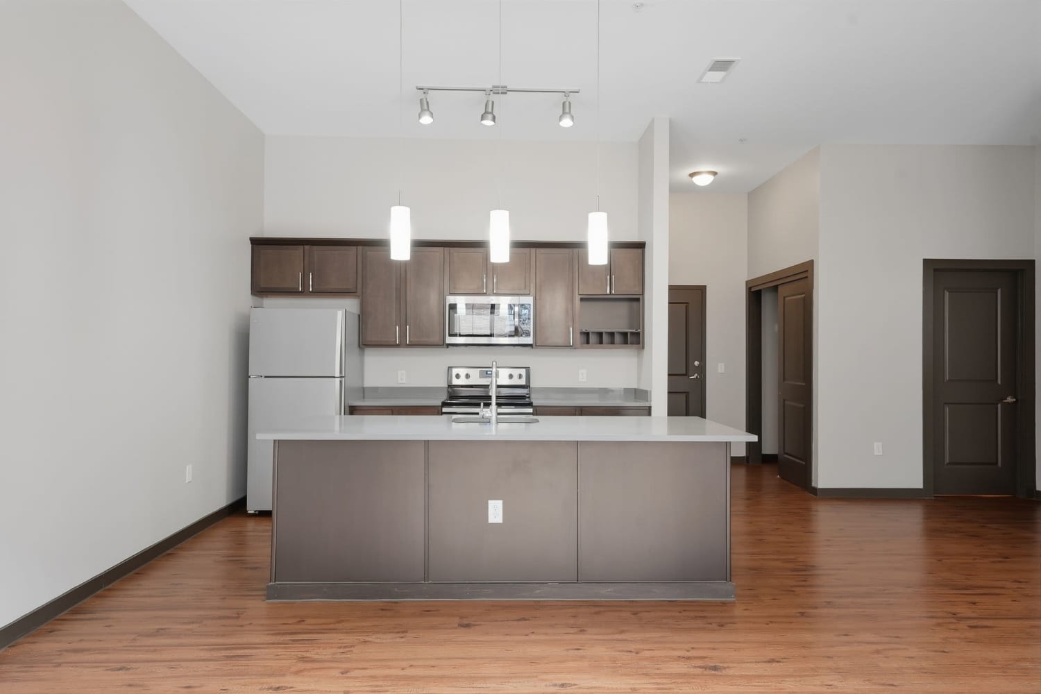 Kitchen with an island and stainless-steel appliances at Bridge Park in Dublin, Ohio