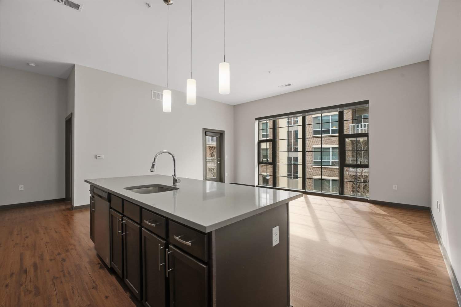 Kitchen in a home with tall windows at Bridge Park in Dublin, Ohio