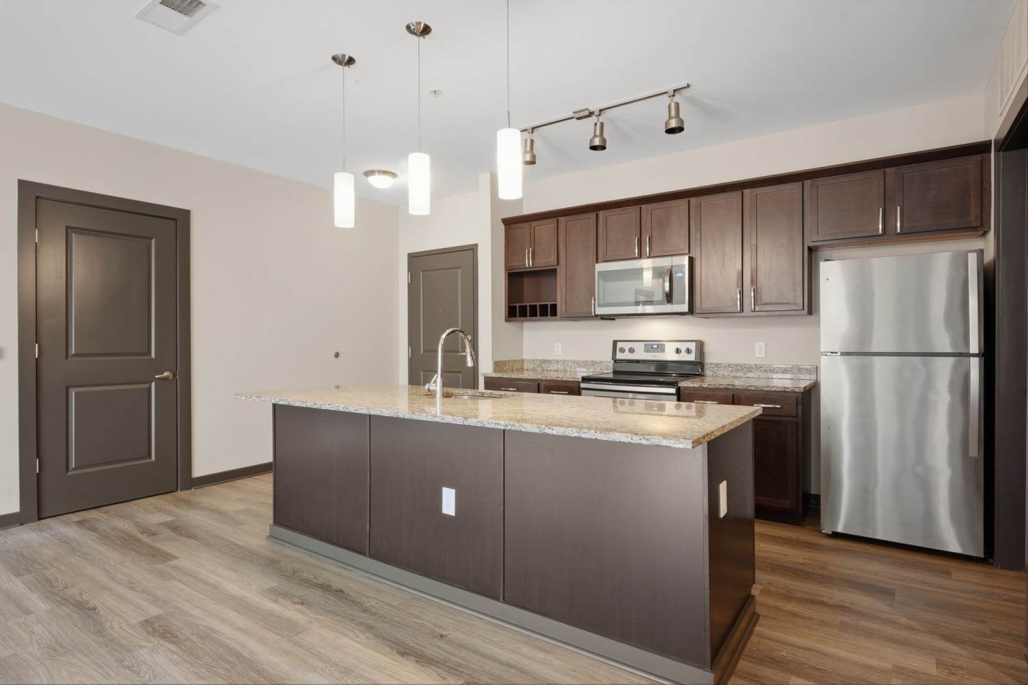 Apartment kitchen with an island at Bridge Park in Dublin, Ohio