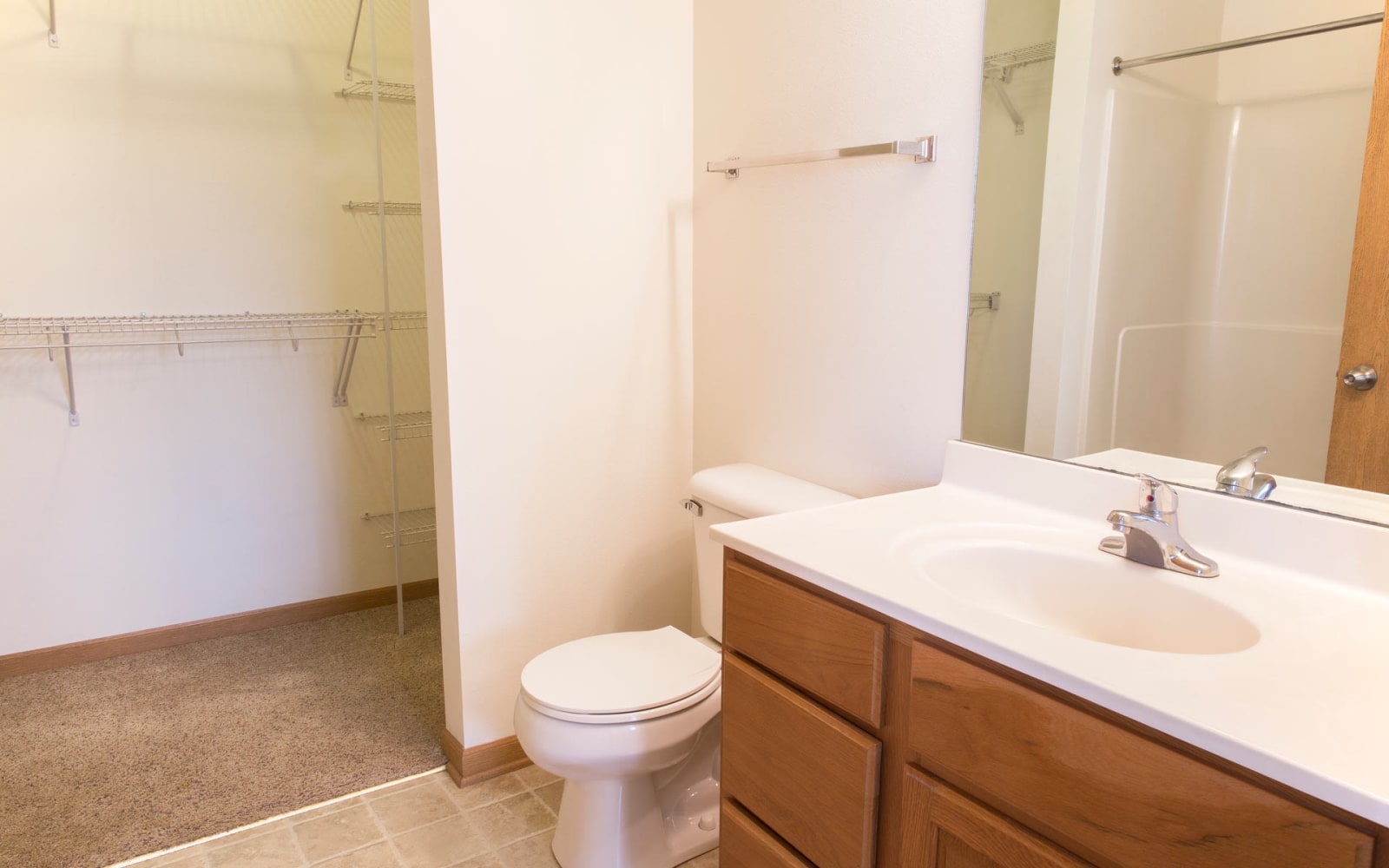 A bathroom attached to a bedroom with a walk in closet at Westwood Village in Ames, Iowa