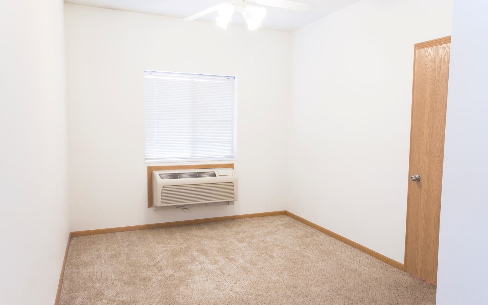 Bedroom with an air conditioning unit at Westwood Village in Ames, Iowa