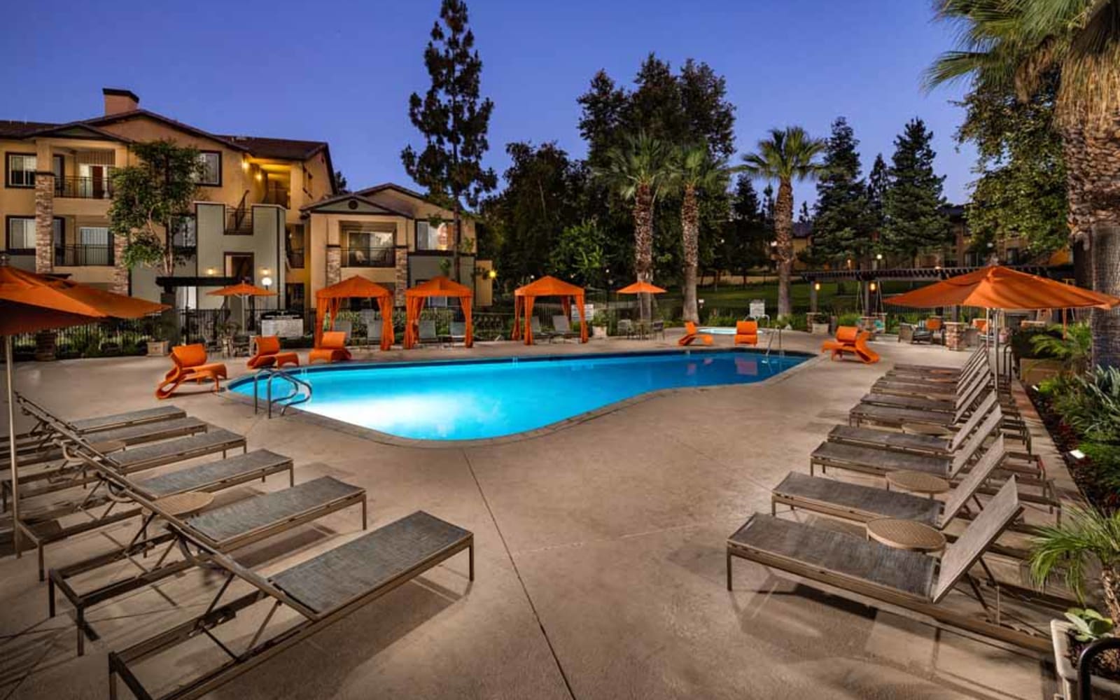 The community pool at dusk at Colonnade at Sycamore Highlands in Riverside, California