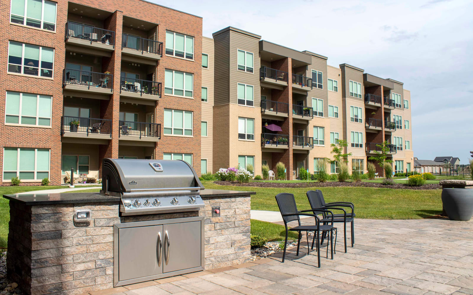 A grill and outdoor seating at Attivo Trail Waukee in Waukee, Iowa