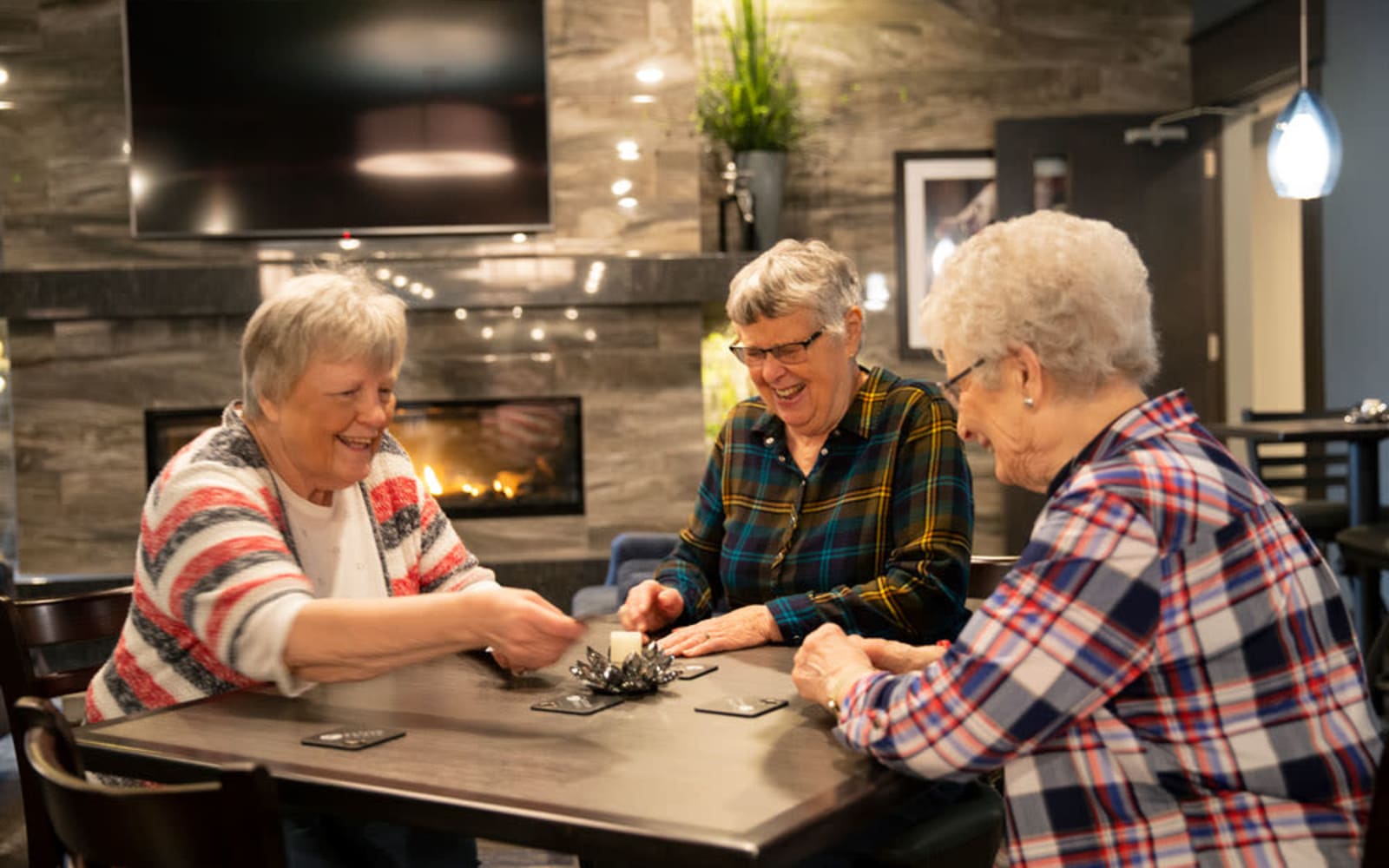 Residents playing cards in the clubhouse at Attivo Trail Waukee in Waukee, Iowa
