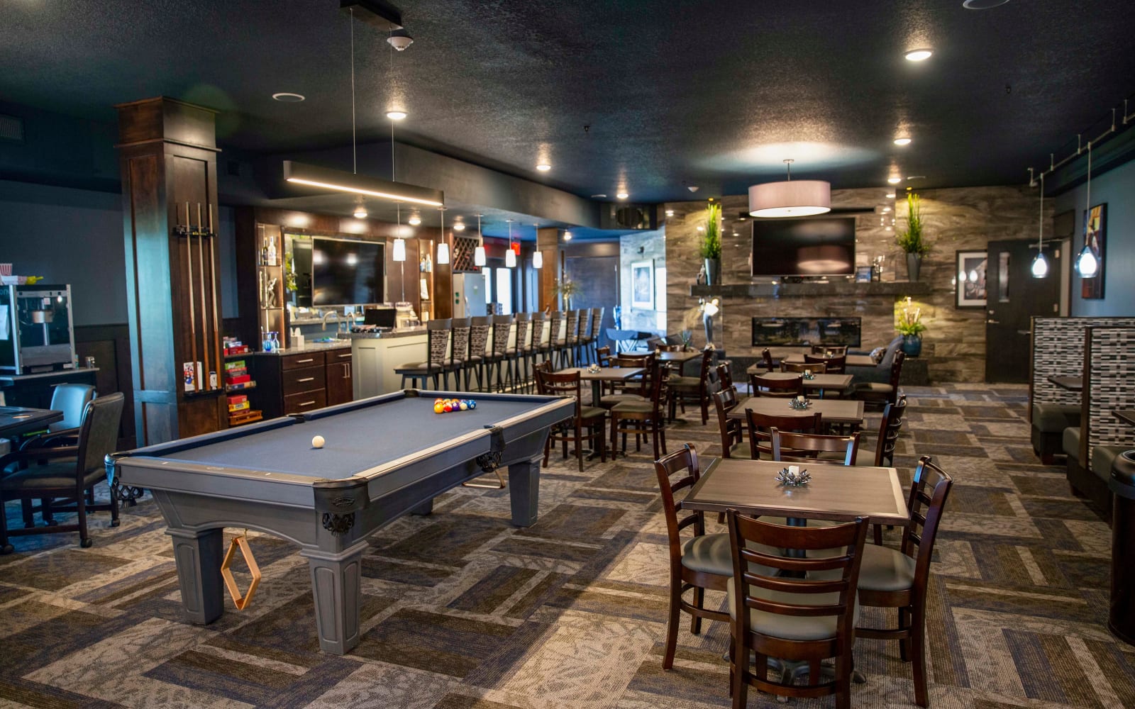 A pool tables and tables and chairs in the clubhouse at Attivo Trail in Ankeny in Ankeny, Iowa