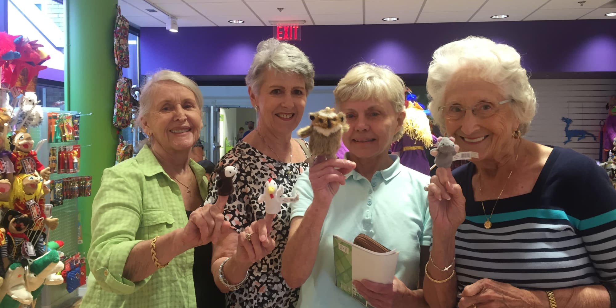 Residents from Somerset Lodge in Gladstone, Oregon holding finger puppets in a store