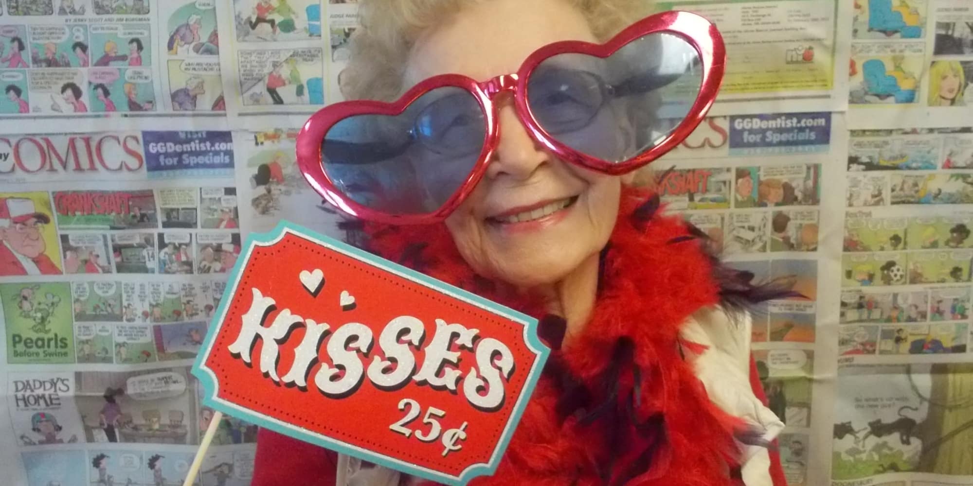 A resident with heart glasses and a kisses for twenty-five cents sign at Somerset Lodge in Gladstone, Oregon