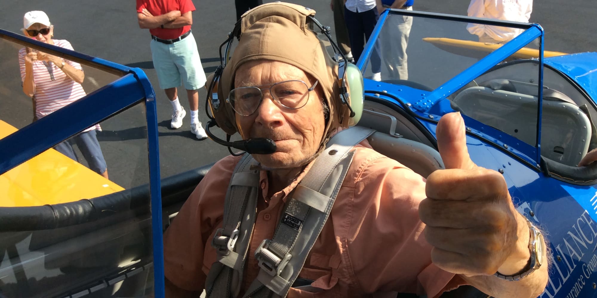 A resident from Southern Pines Gracious Retirement Living in Southern Pines, North Carolina giving a thumbs up from inside an airplane