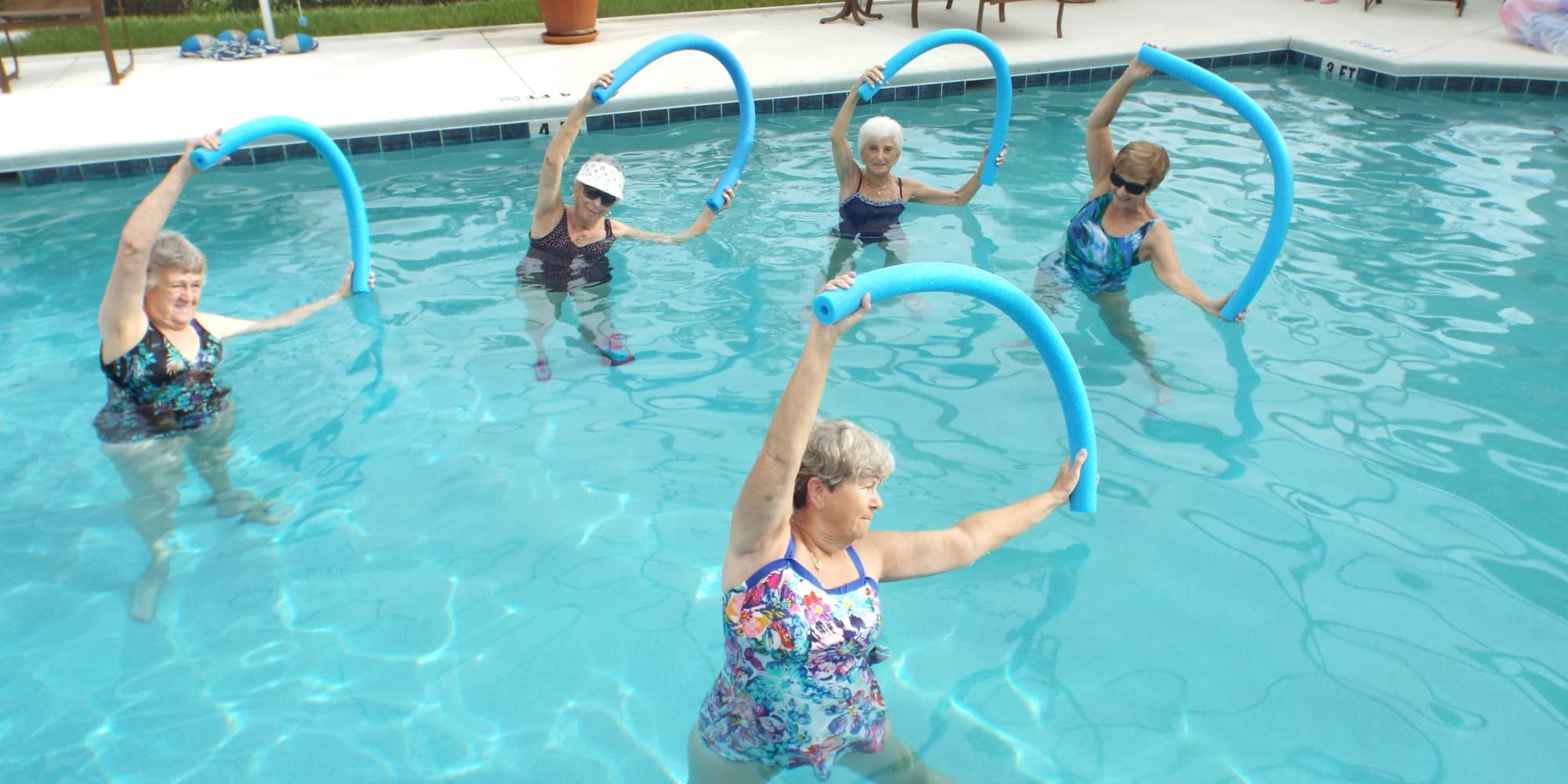 Residents exercising in the pool at The Carriage House Gracious Retirement Living in Oxford, Florida