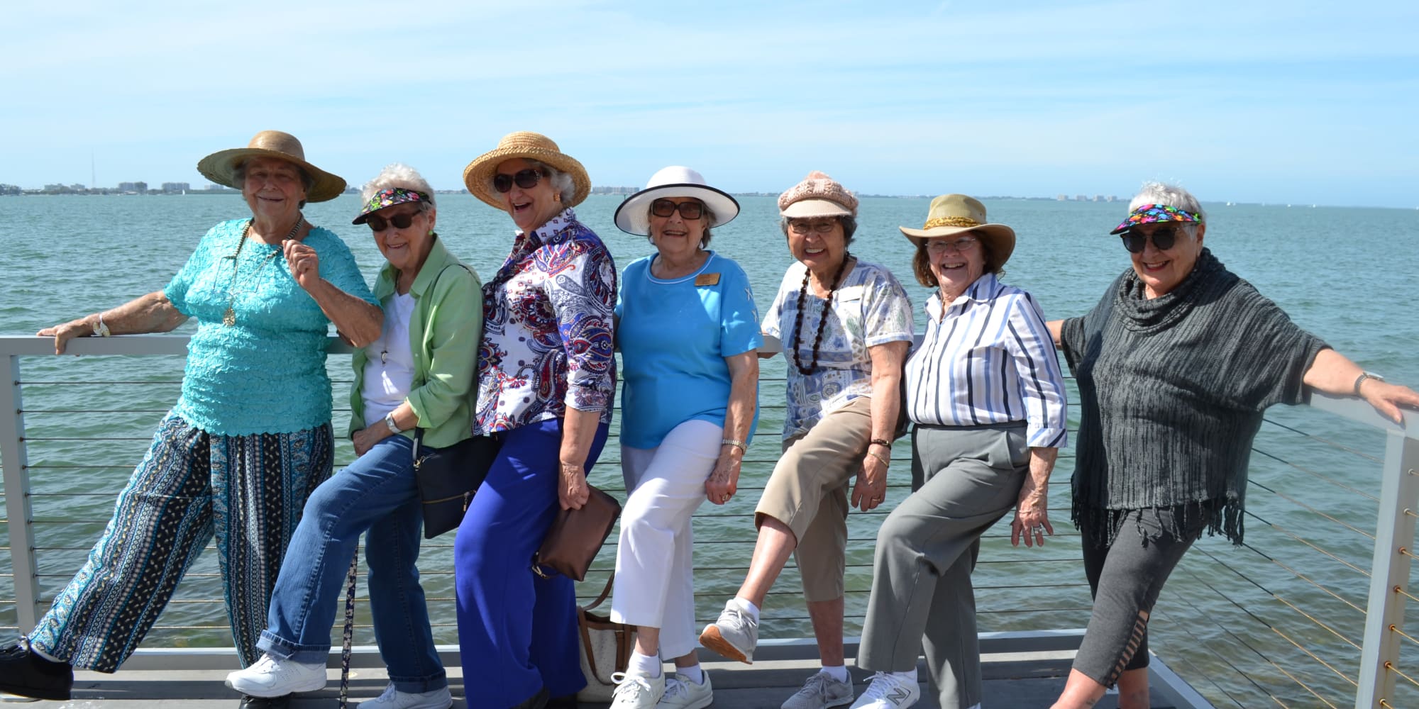 Residents from The Palms at LaQuinta Gracious Retirement Living in La Quinta, California posing on the waterfront