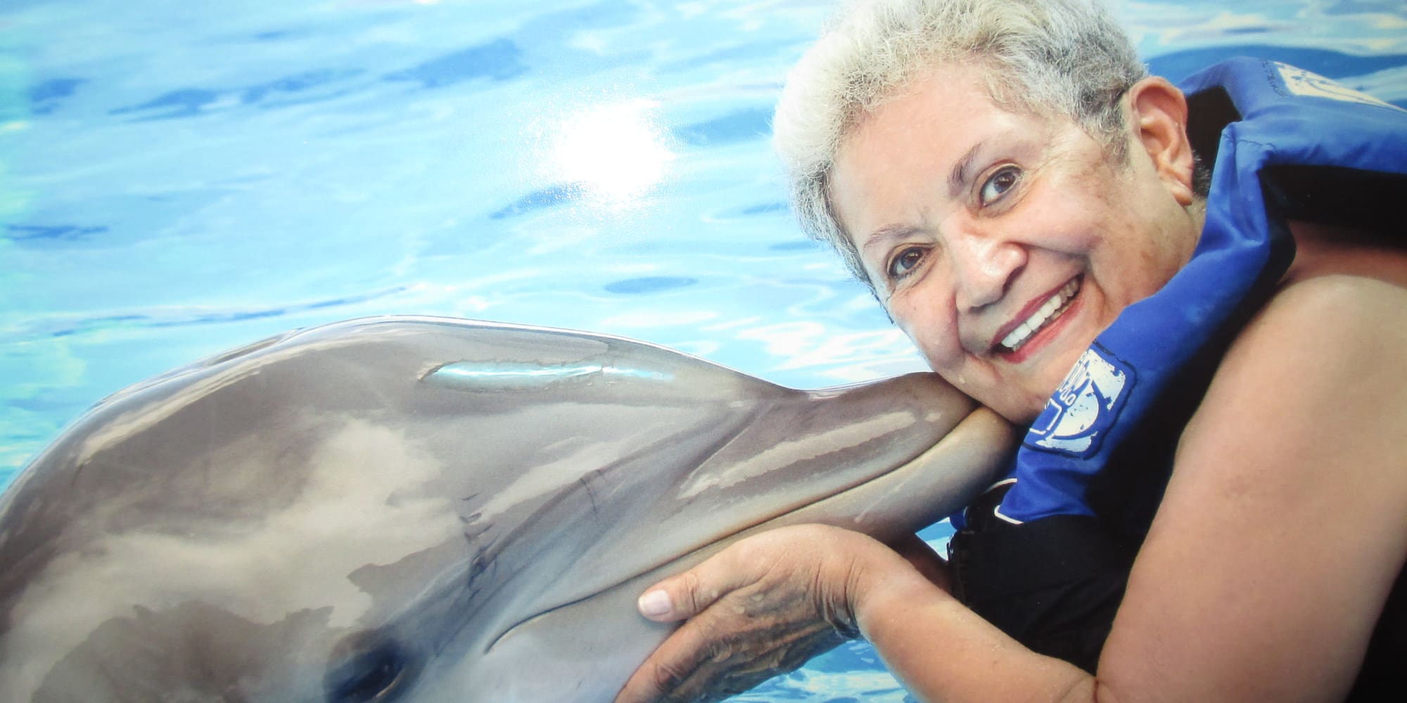 A resident from The Peaks at Santa Rita in Green Valley, Arizona with a dolphin