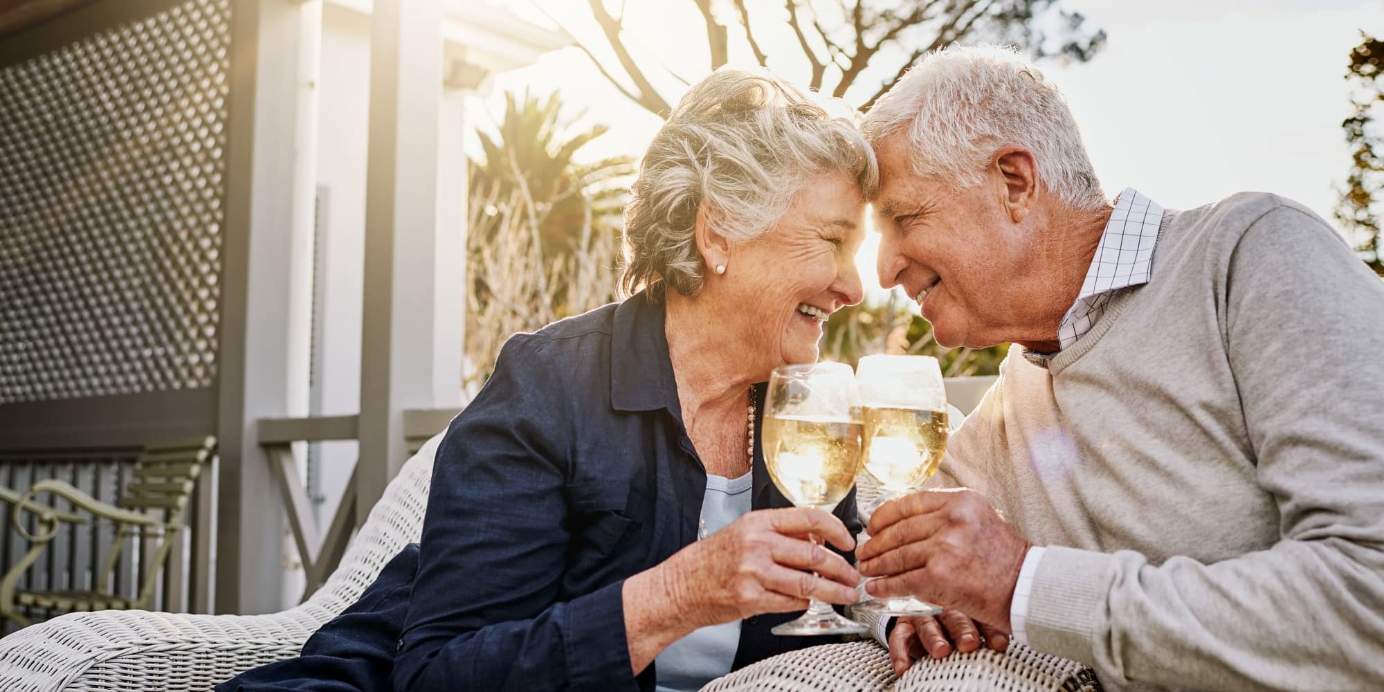 Two residents sharing a glass of wine at Touchmark at Emerald Lake in McKinney, Texas