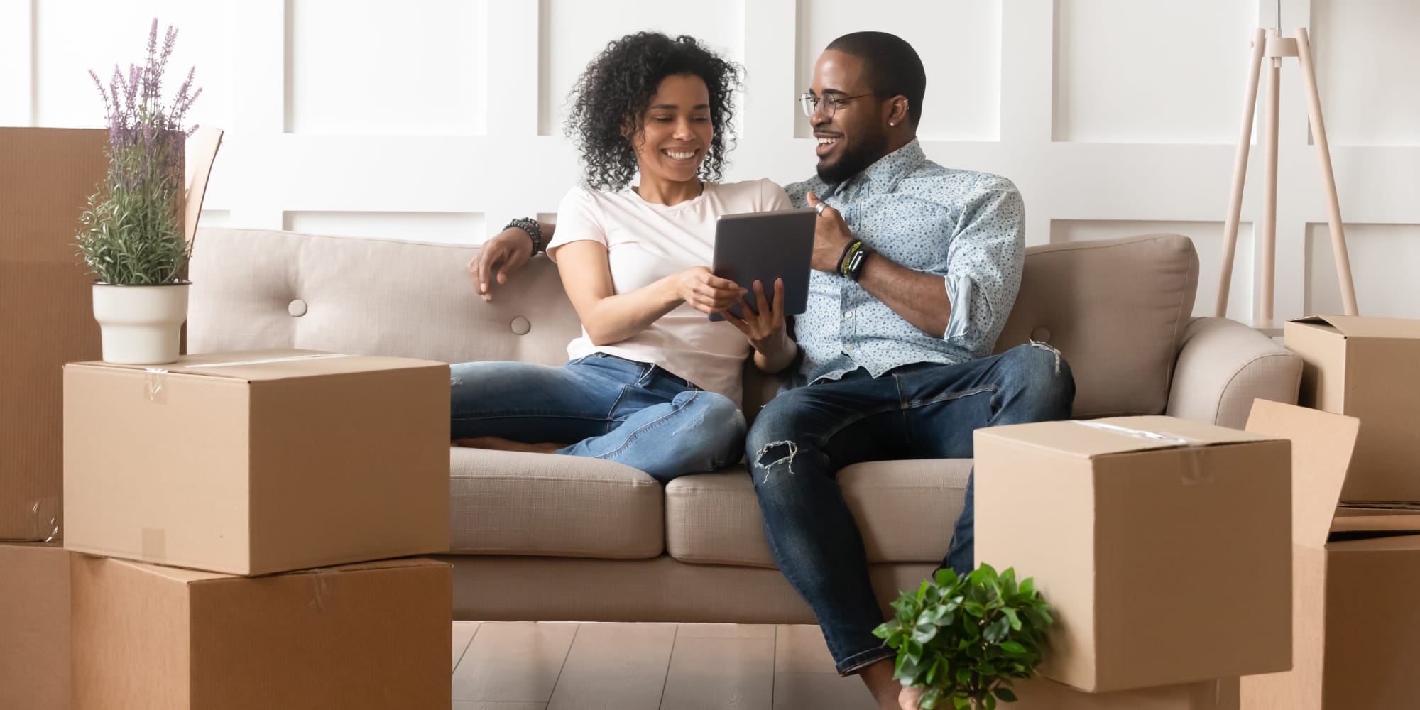 Couple moving boxes into living room at A3 Storage Centers in Wolfforth, Texas