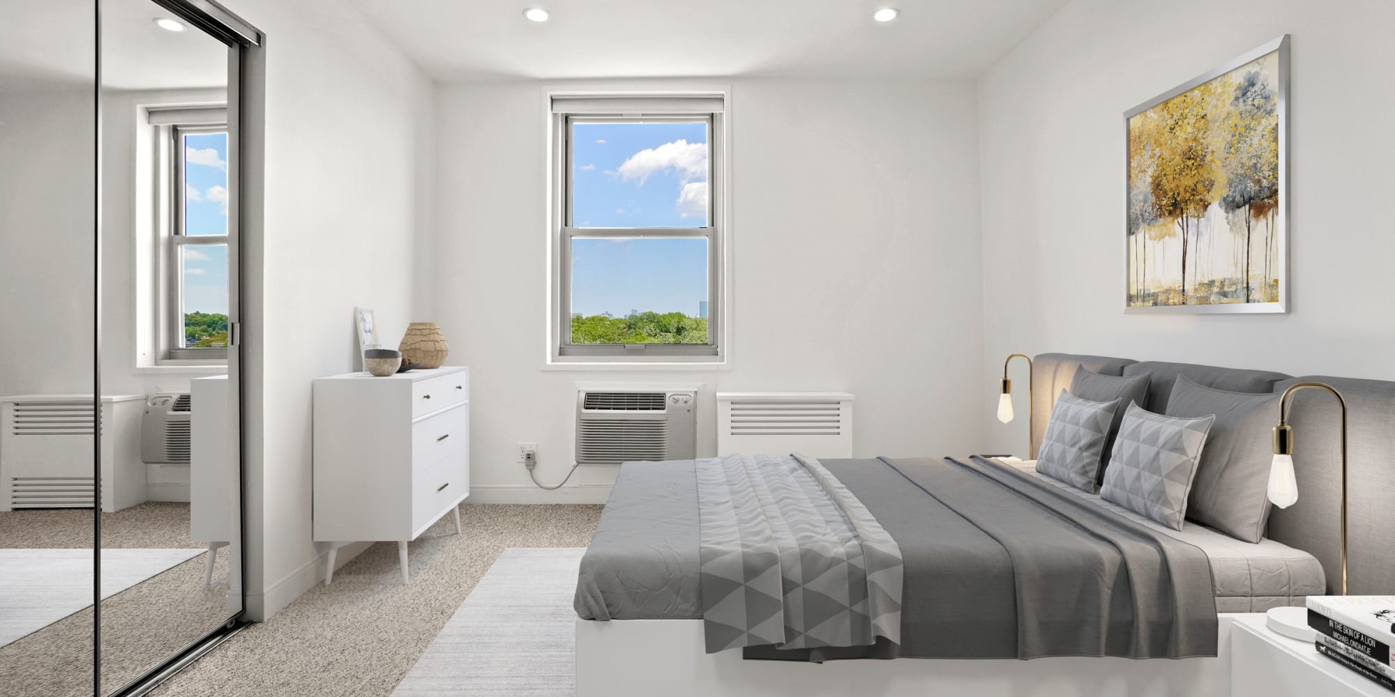 Bedroom with mirror closet doors at Camelot Court in Brighton, Massachusetts