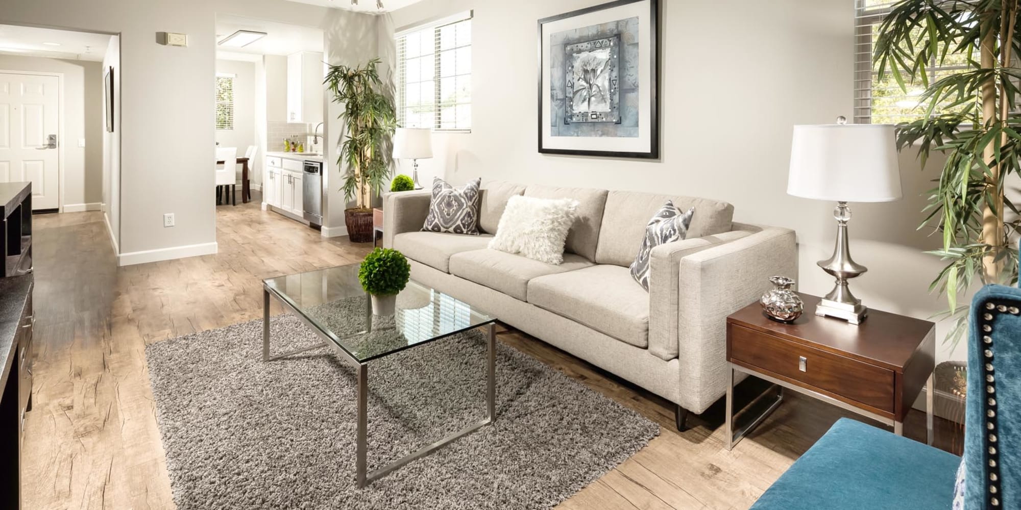 Hardwood flooring in the well-furnished living area of a model home at Mission Hills in Camarillo, California