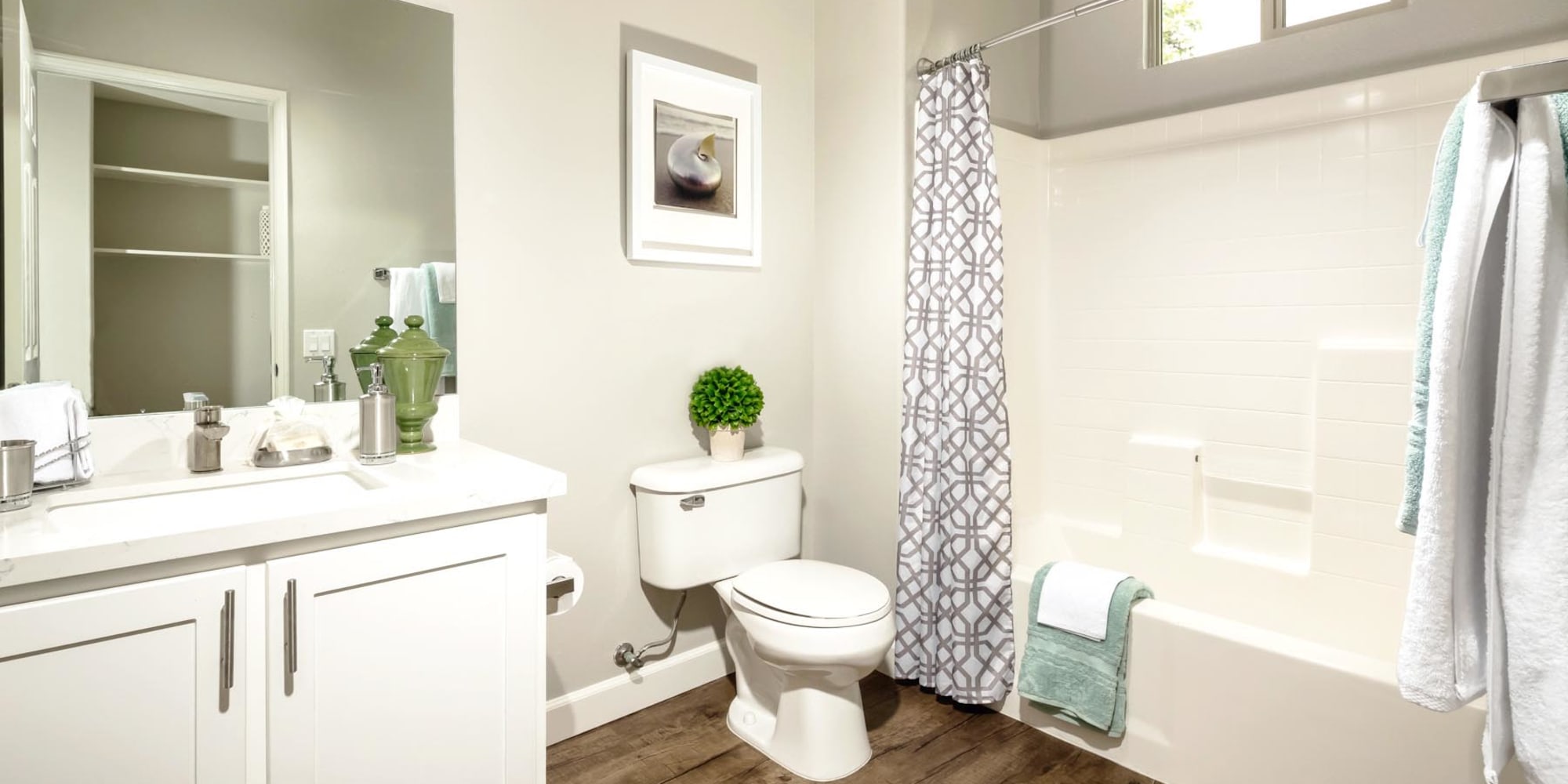 Tiled shower and a large vanity mirror in a model home at Mission Hills in Camarillo, California