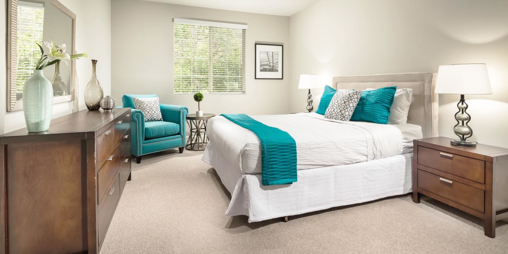 Classic furnishings and plush carpeting in a model home's primary bedroom at Mission Hills in Camarillo, California
