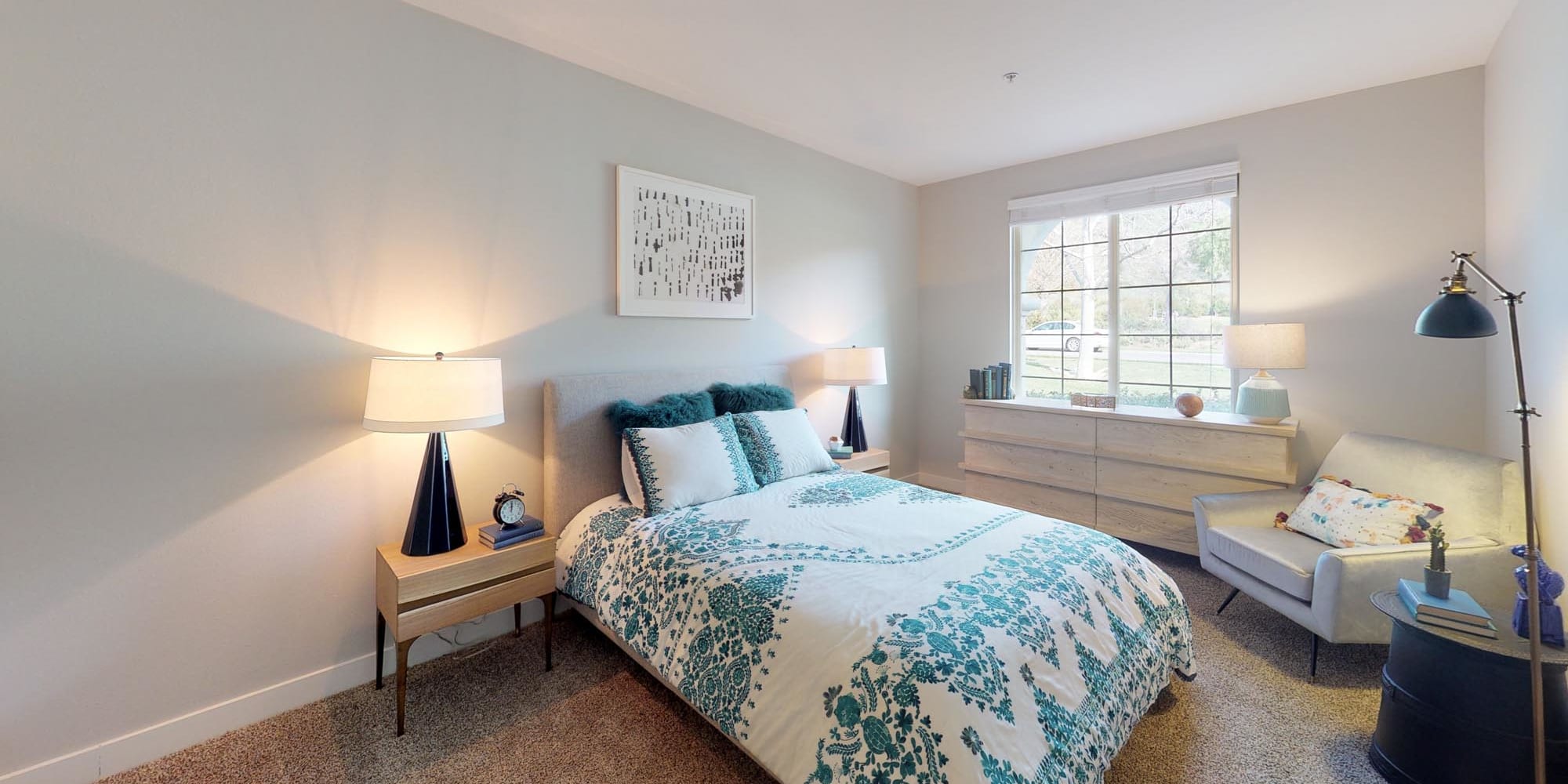 Plush carpeting and a large bay window in a model apartment's bedroom at Mission Hills in Camarillo, California