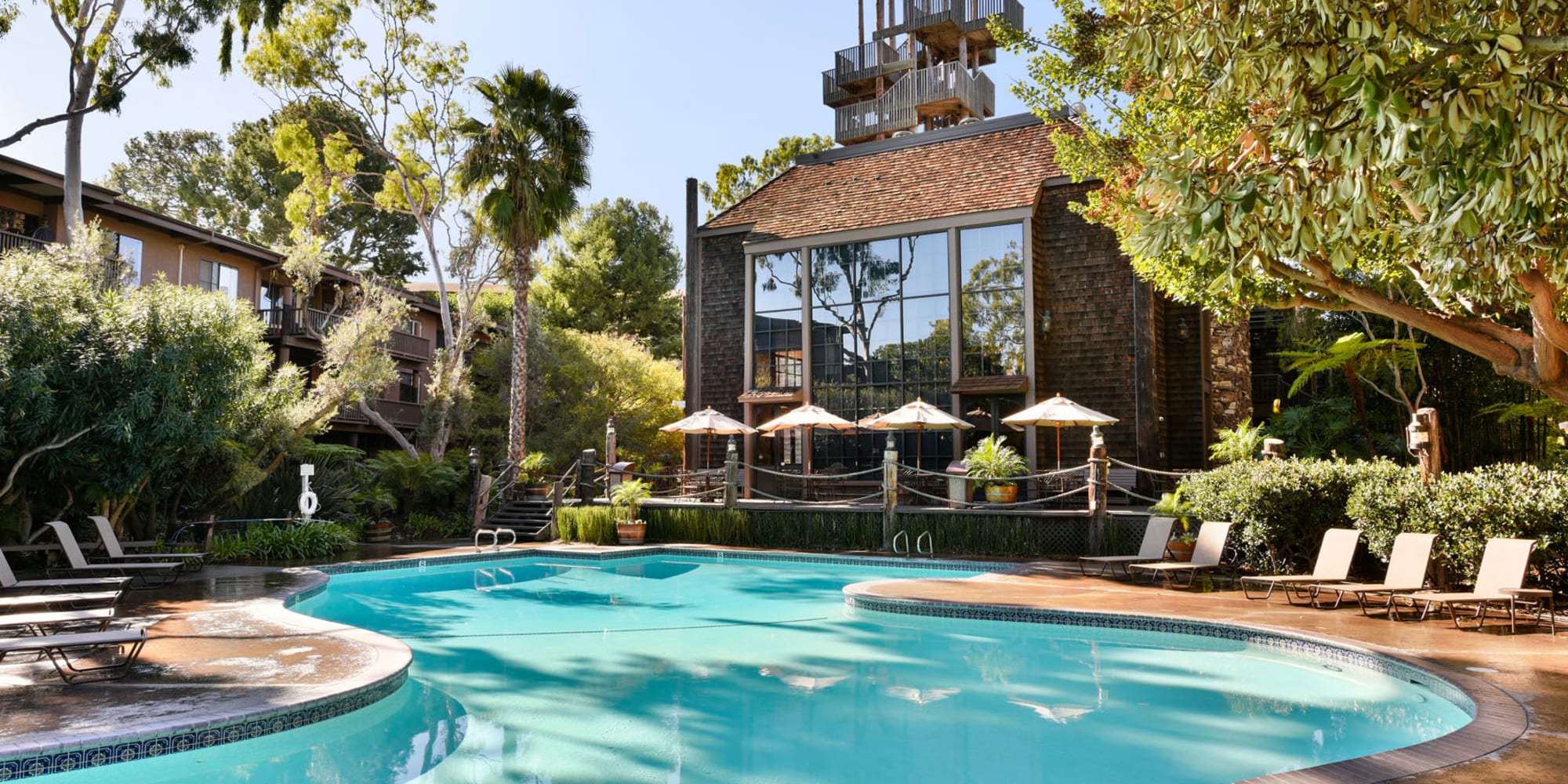 Resort-style swimming pool surrounded by mature trees at Mariners Village in Marina del Rey, California