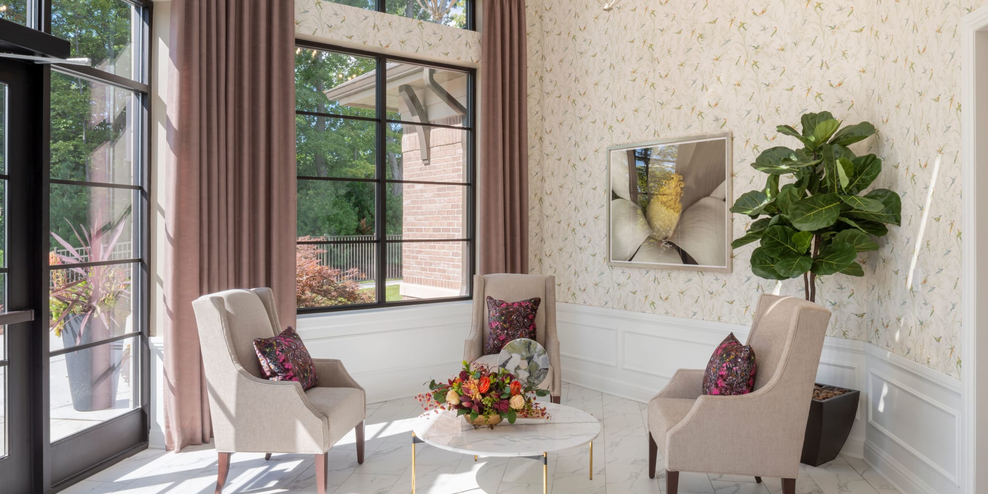 Reading room with large windows and a door to the outside at Blossom Collection in Rochester, Michigan