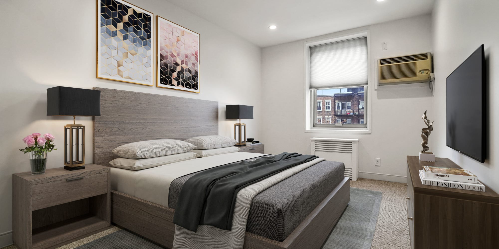 Bedroom with wood-style flooring at Camelot Court in Brighton, Massachusetts