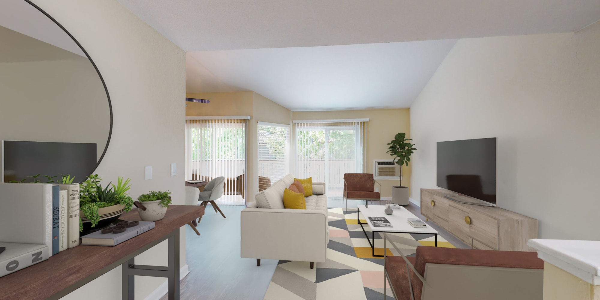 Two-bedroom apartment's living area with bay windows and plank flooring at Valley Plaza Villages in Pleasanton, California